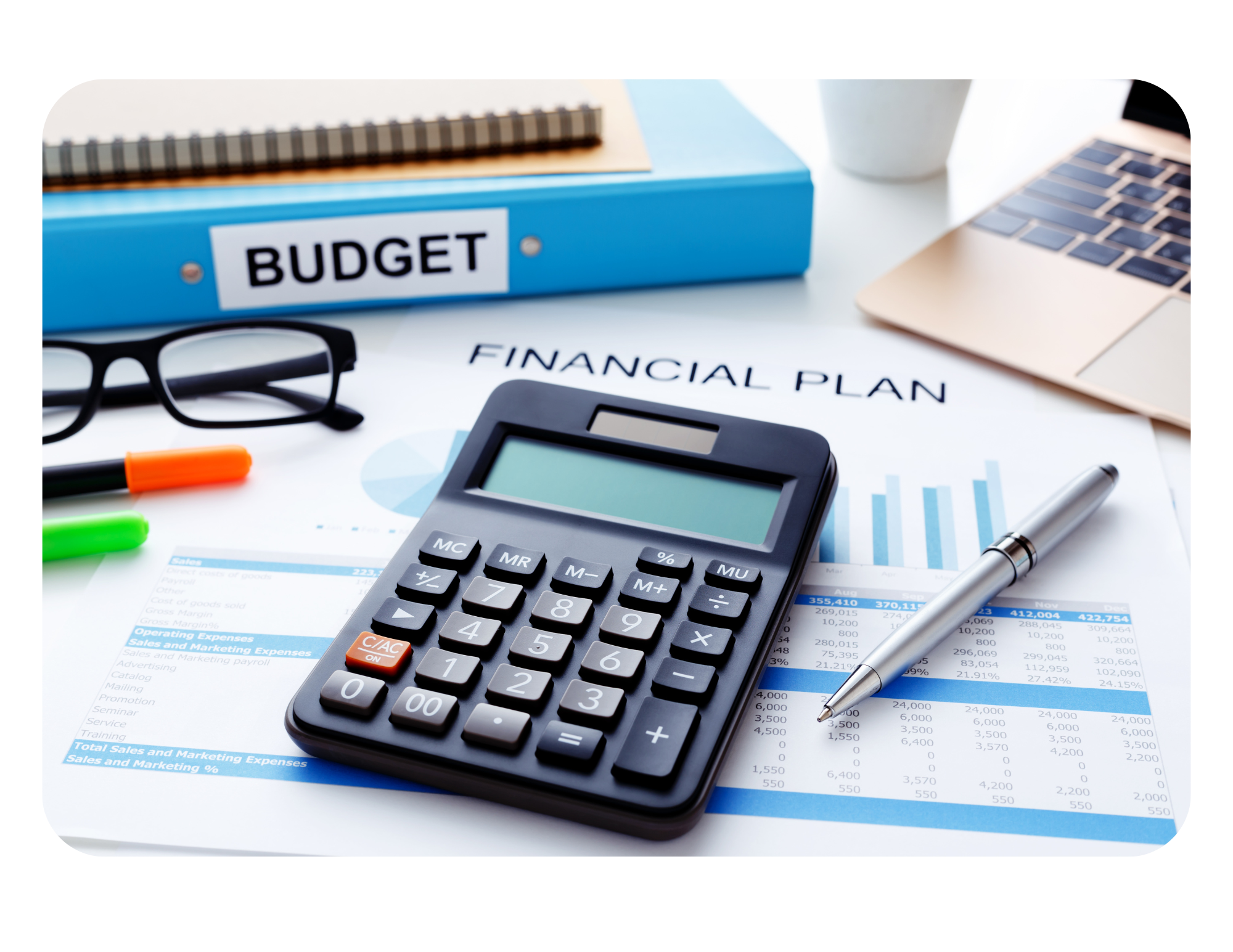 Office desk with a calculator, pen, financial documents labeled 'Financial Plan,' glasses, pens, a blue binder labeled 'Budget,' and a laptop