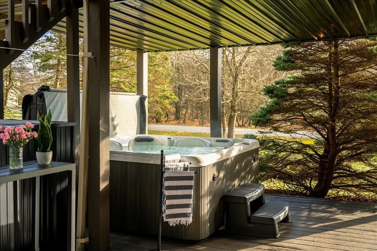 Outdoor hot tub at the lodge with warm lighting and relaxing atmosphere at night