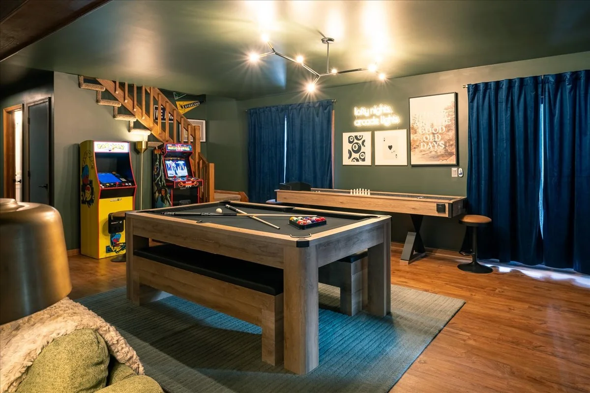 Lodge game room with pool table arcade machines and entertainment space