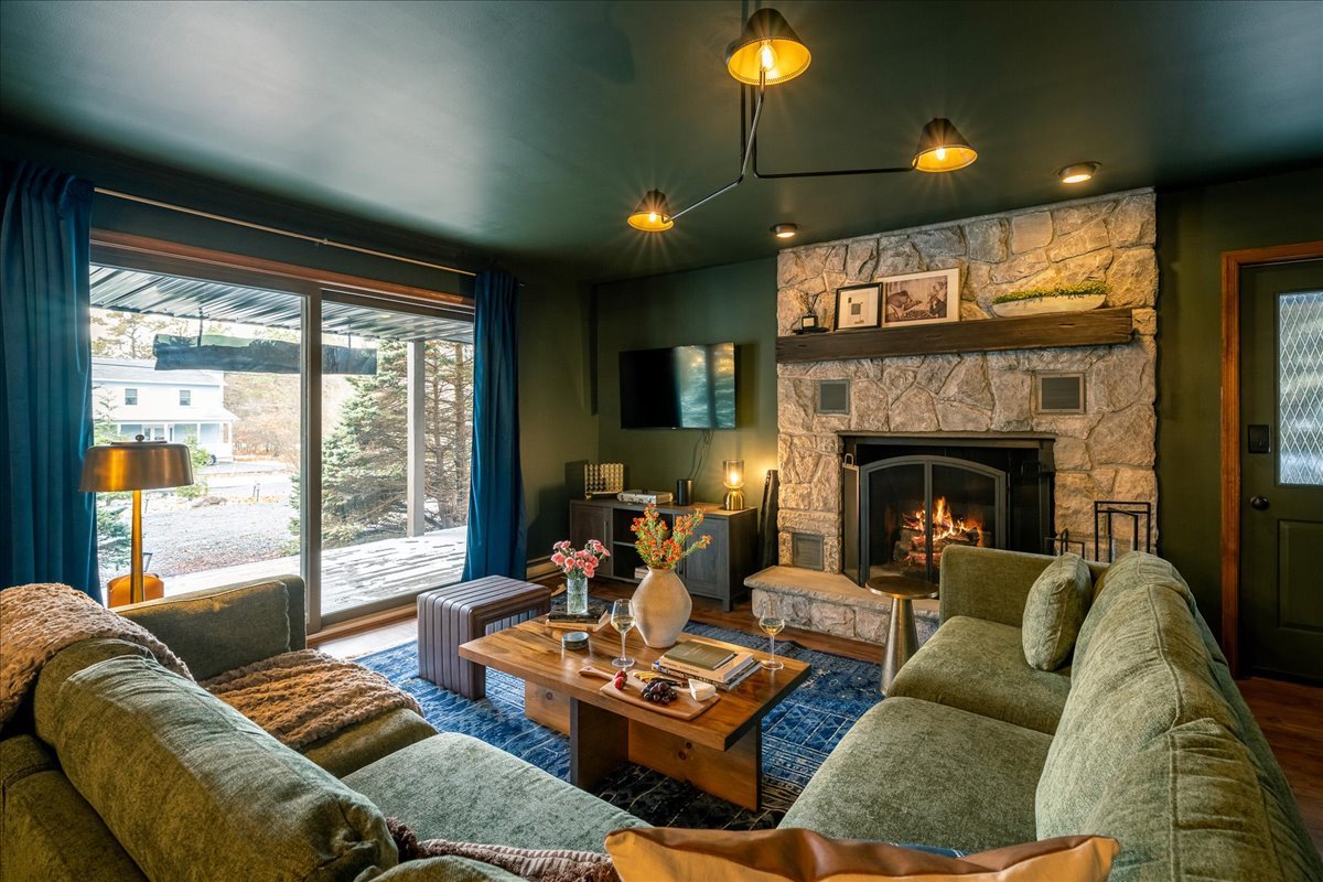 Bright sun room at the lodge with large windows natural light and cozy seating