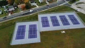 Aerial view of a building with multiple solar panel installations on the roof.
