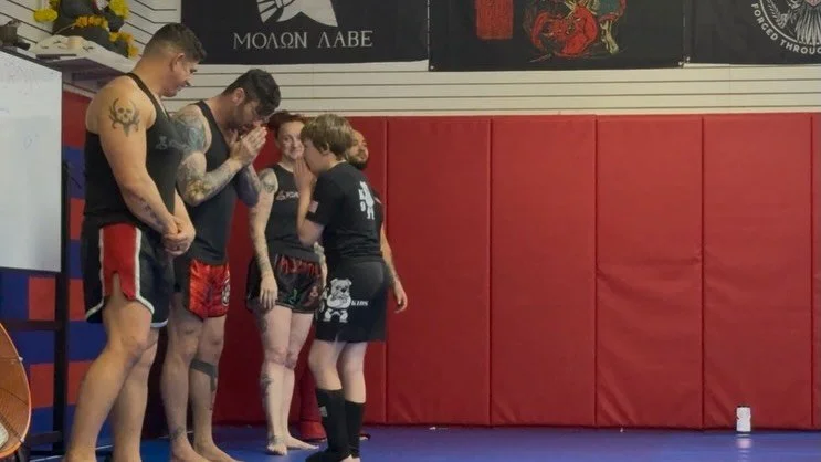 Muay Thai students receiving their rank patches, under Berserker Muay Thai @ninerealmsmma