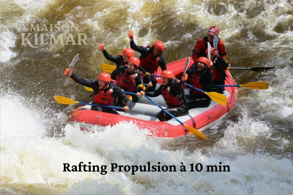 Six people in a red inflatable raft wearing helmets and life jackets, whitewater rafting on a river.
