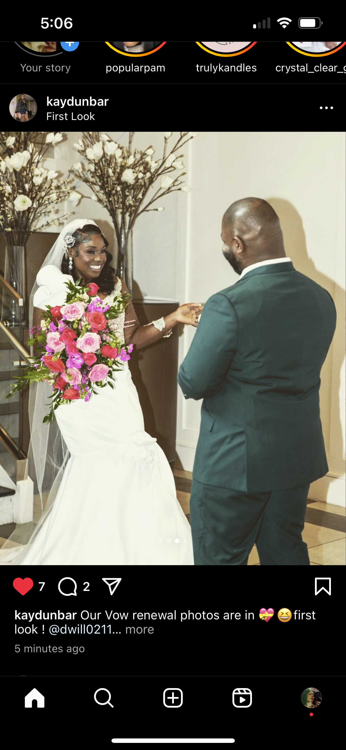 Bride and groom sharing a moment during a wedding ceremony, with the bride holding a pink and purple flower bouquet, standing next to a floral arrangement in the background.
