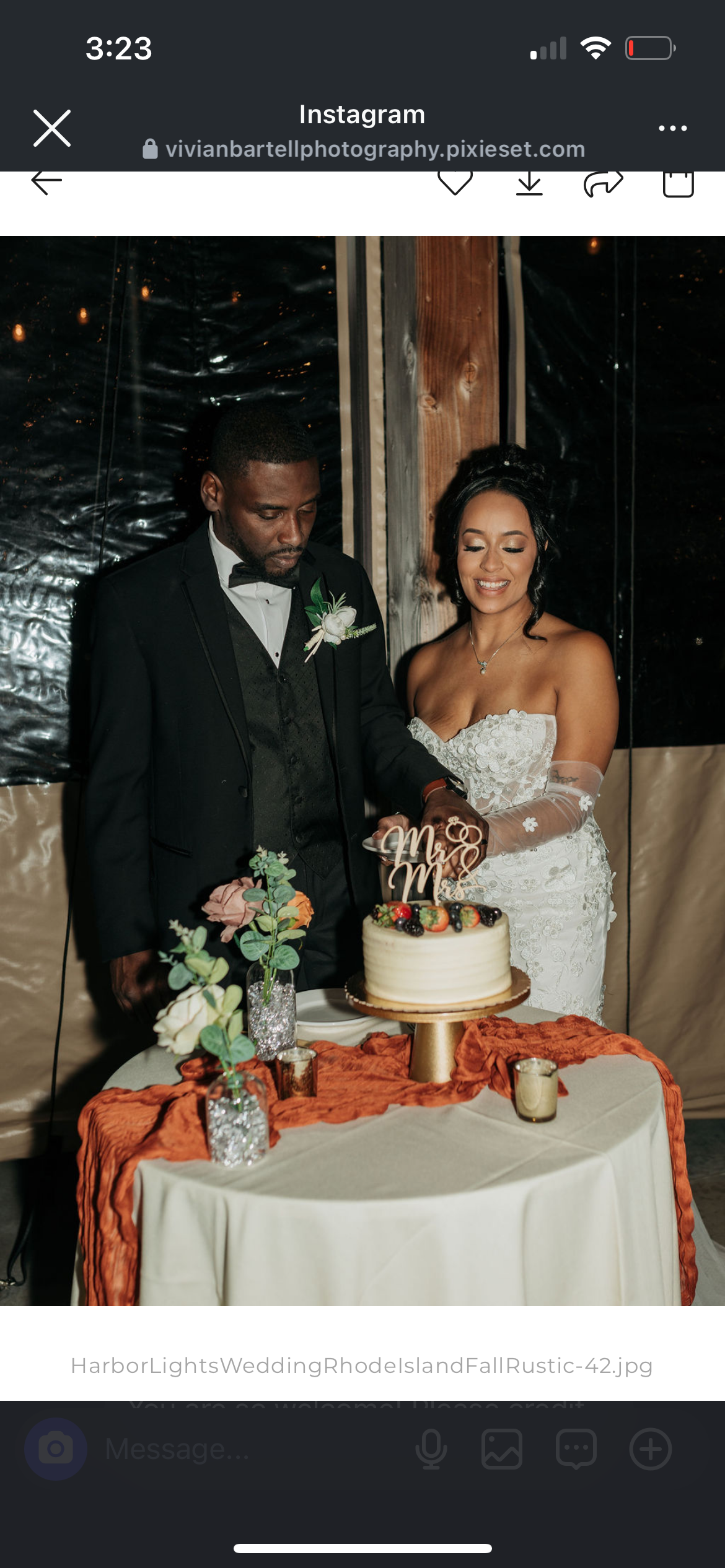A bride and groom cutting a wedding cake together at their wedding reception.