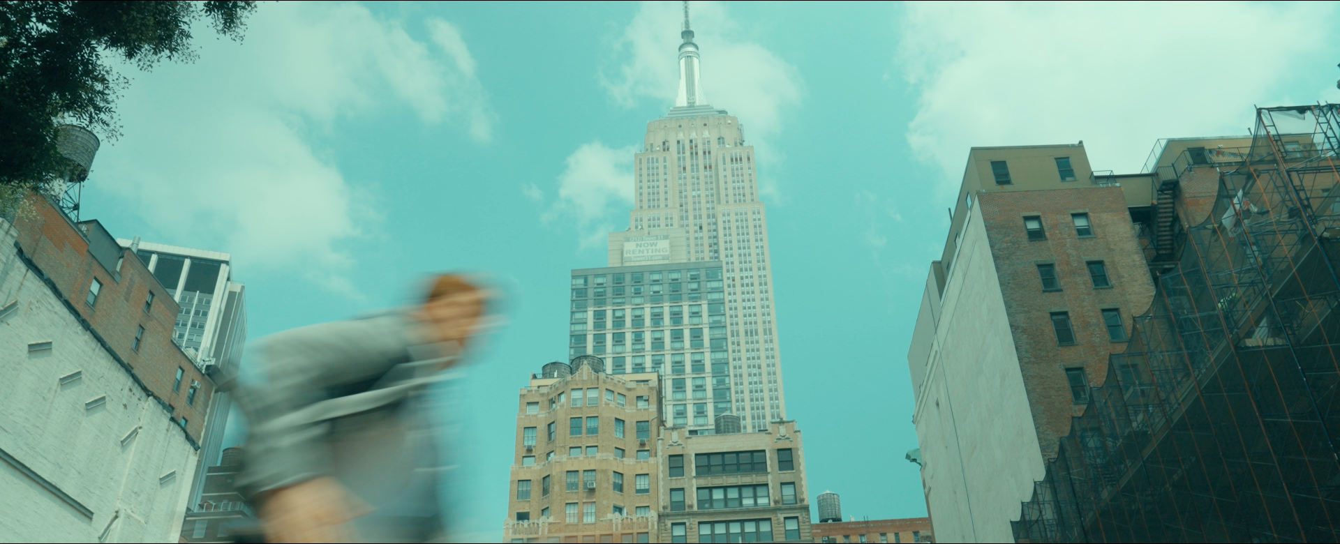 Cooper runs past the Empire State Building in New York City on his way to the real Interview