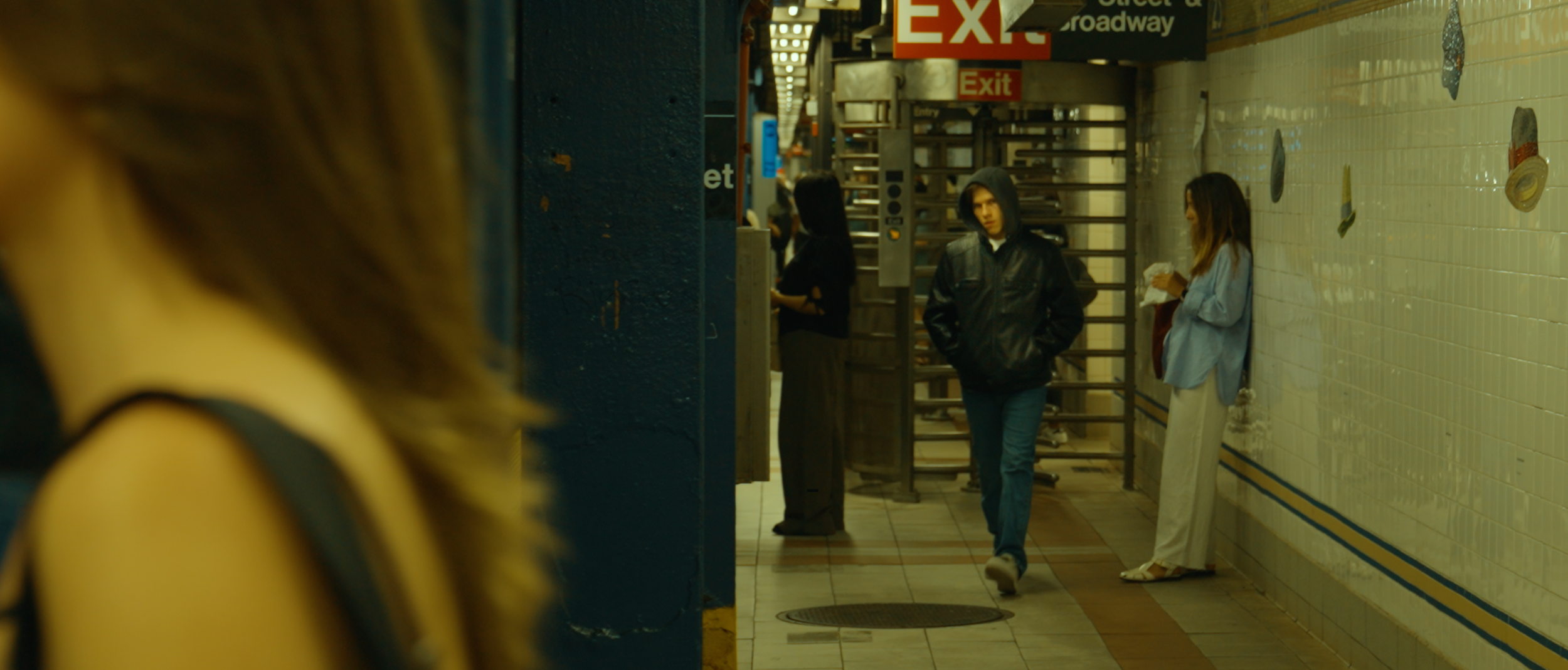 The stalker follows Carol into the 23rd street N R subway stop in New York City