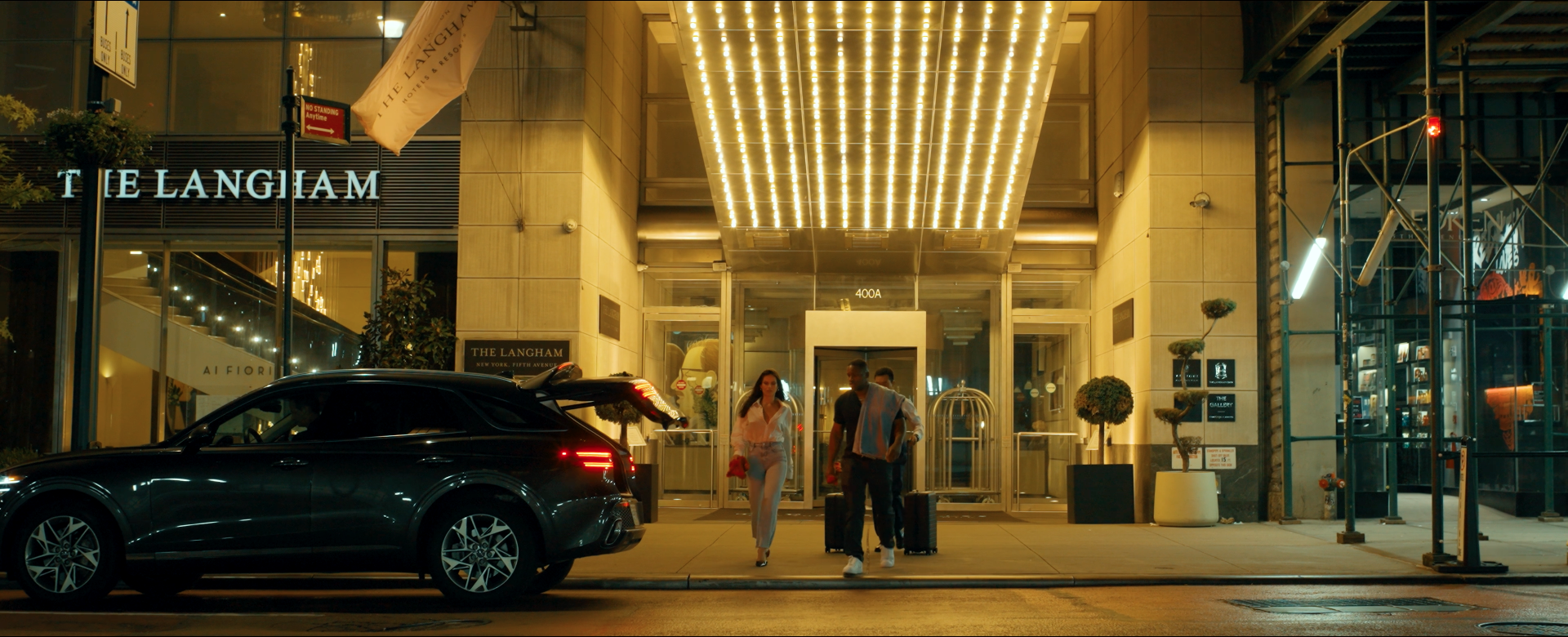 Joe, Renee, and the porter walk to the Uber to make their getaway in Another Day in New York