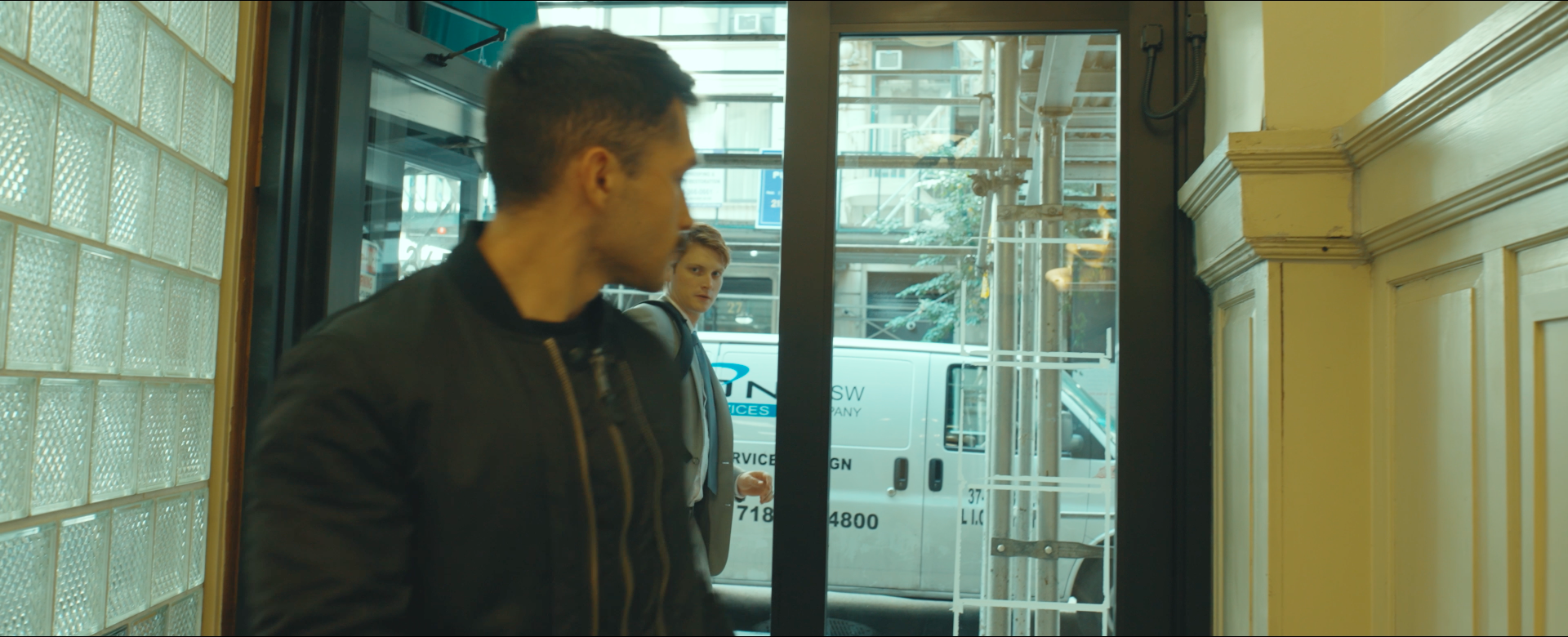 Cooper walks by the Real Hitman in Another Day in New York