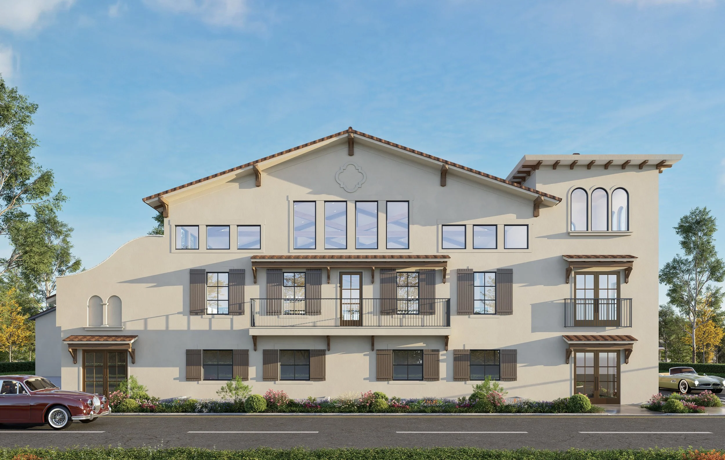 A modern, multi-story residential building with beige stucco exterior, brown shutters, and wooden accents under a clear blue sky with trees and classic cars parked in front.