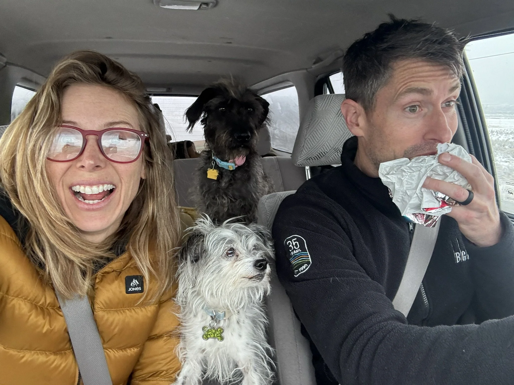 Kelsey, husband, and two dogs in a car