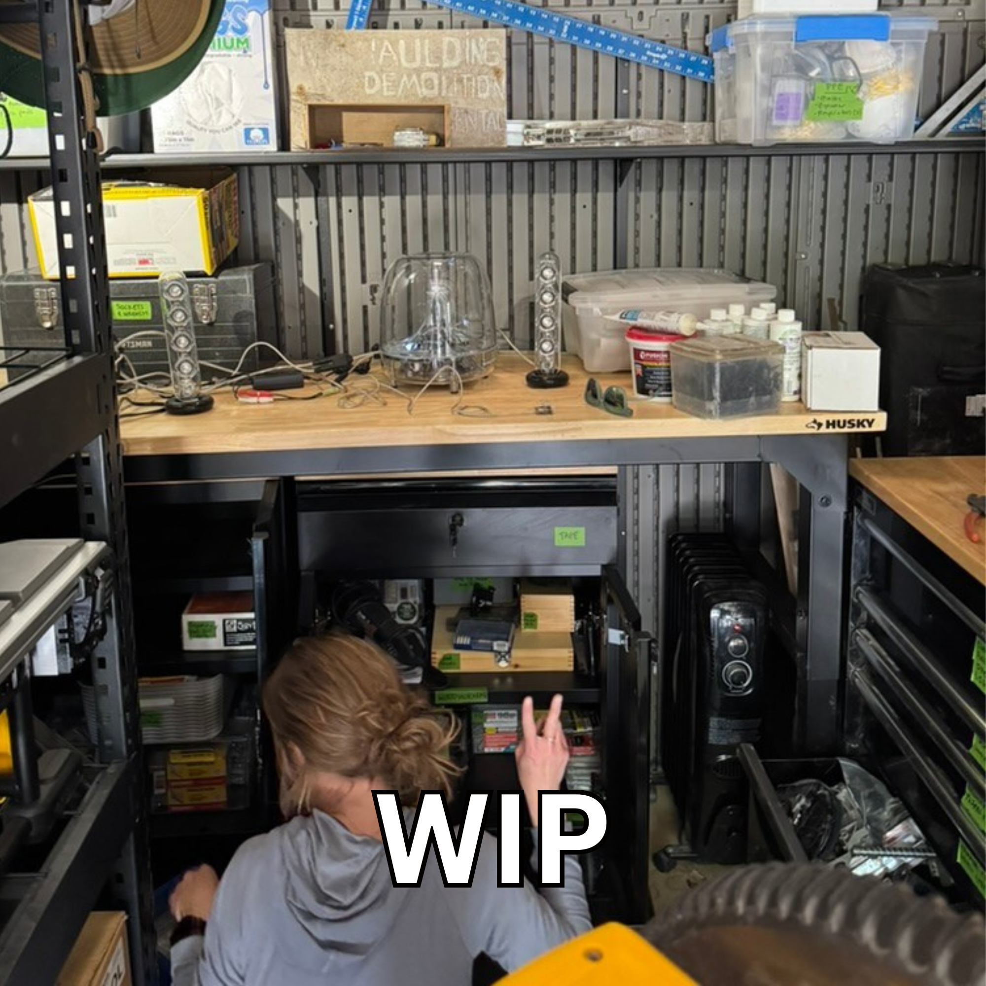 Kelsey working on organizing tools in a shed