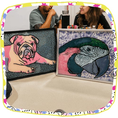 Two paintings of animals in front of two adults at art class at Artside In in Oceanside, NY