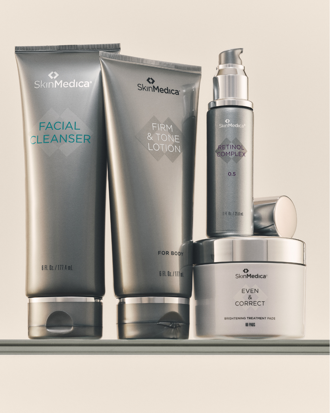 Collection of SkinMedica skincare products including facial cleanser, firm and tone lotion, retinol complex, and brightening treatment pads.