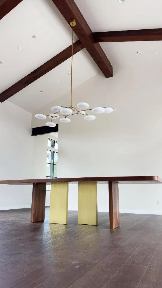 Walnut dining table with brass-wrapped legs