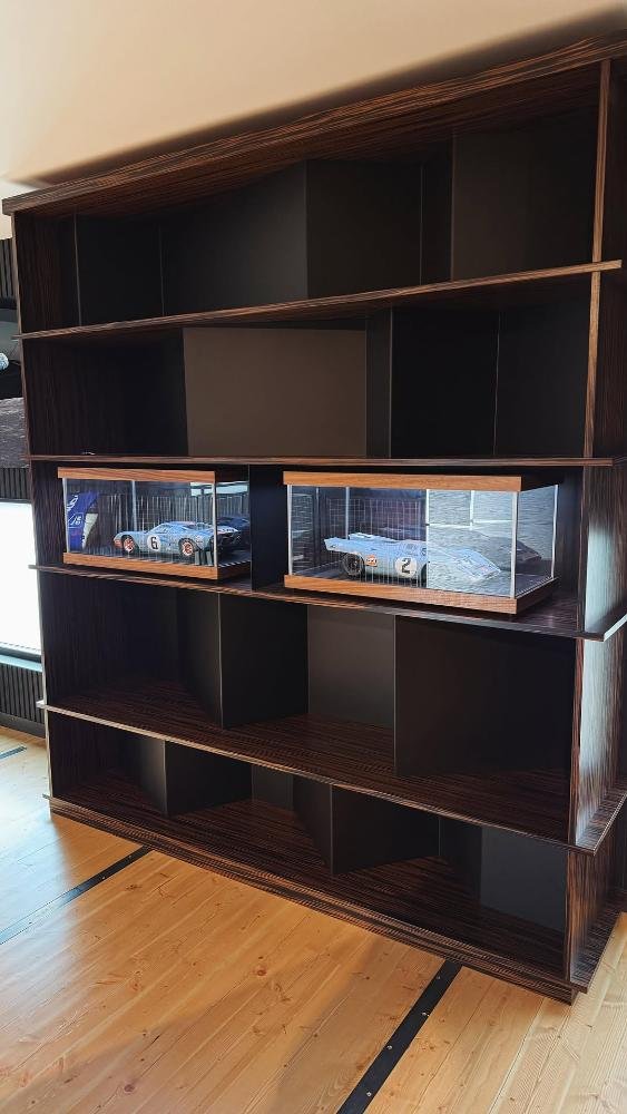 Bent steel library shelving with Macassar ebony veneer