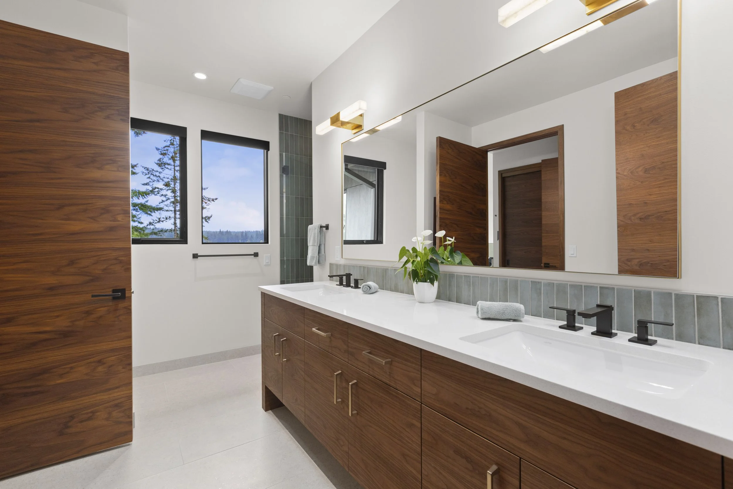 Secondary bathroom with custom walnut double vanity and full-width mirror