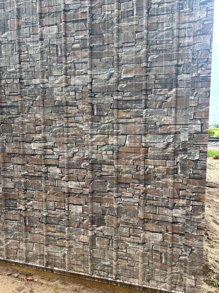 Close-up of a wall with textured stone or brick pattern.