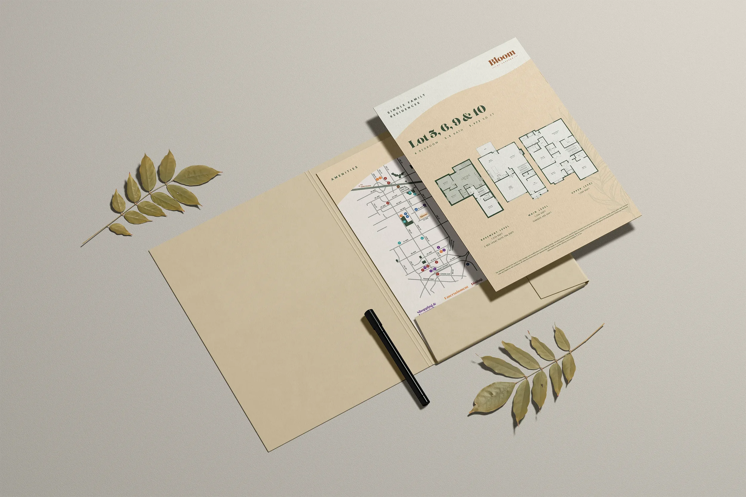 An open presentation folder that shows the inserts for a single family home floor plan and local amenities.