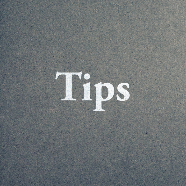 The word "Tips" written in white text on a dark gray background.