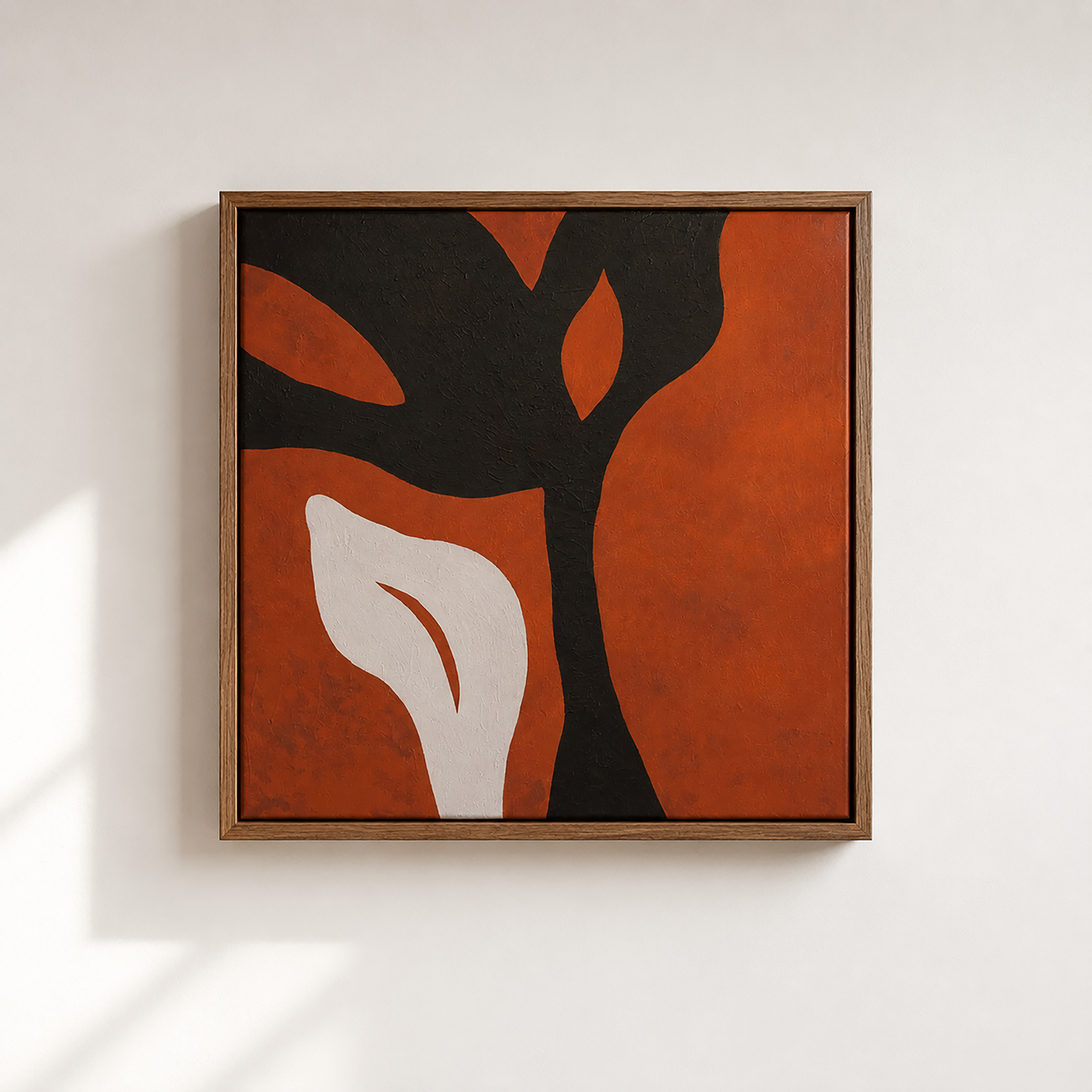 Framed modern abstract painting with black and orange shapes on canvas, mounted on a white wall.