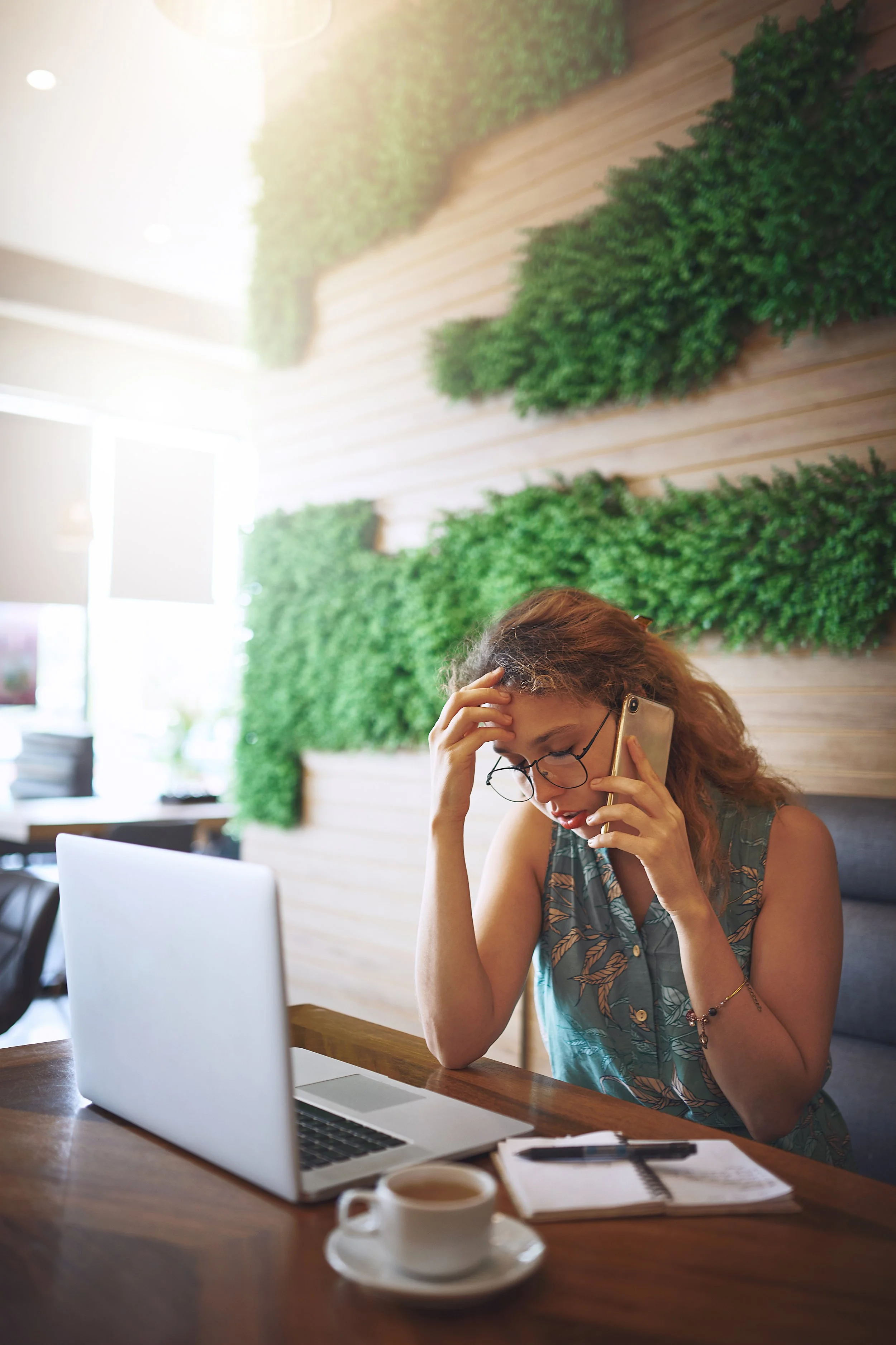 A frustrated woman navigating multiple phone menus while trying to schedule a doctor’s appointment.