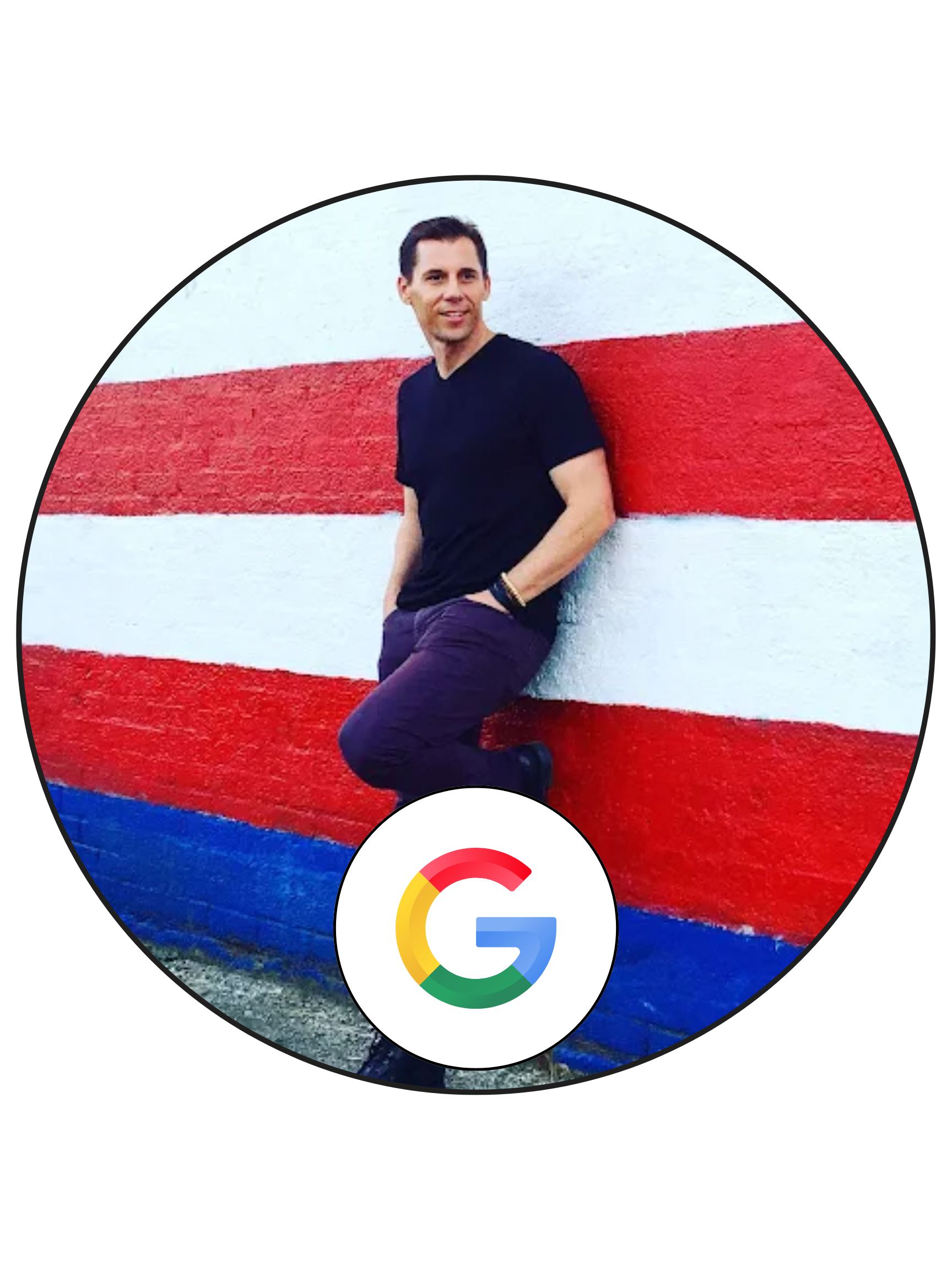 A man in black shirt and dark pants leaning against a wall with red, white, and blue horizontal stripes, with a Google logo in the foreground.
