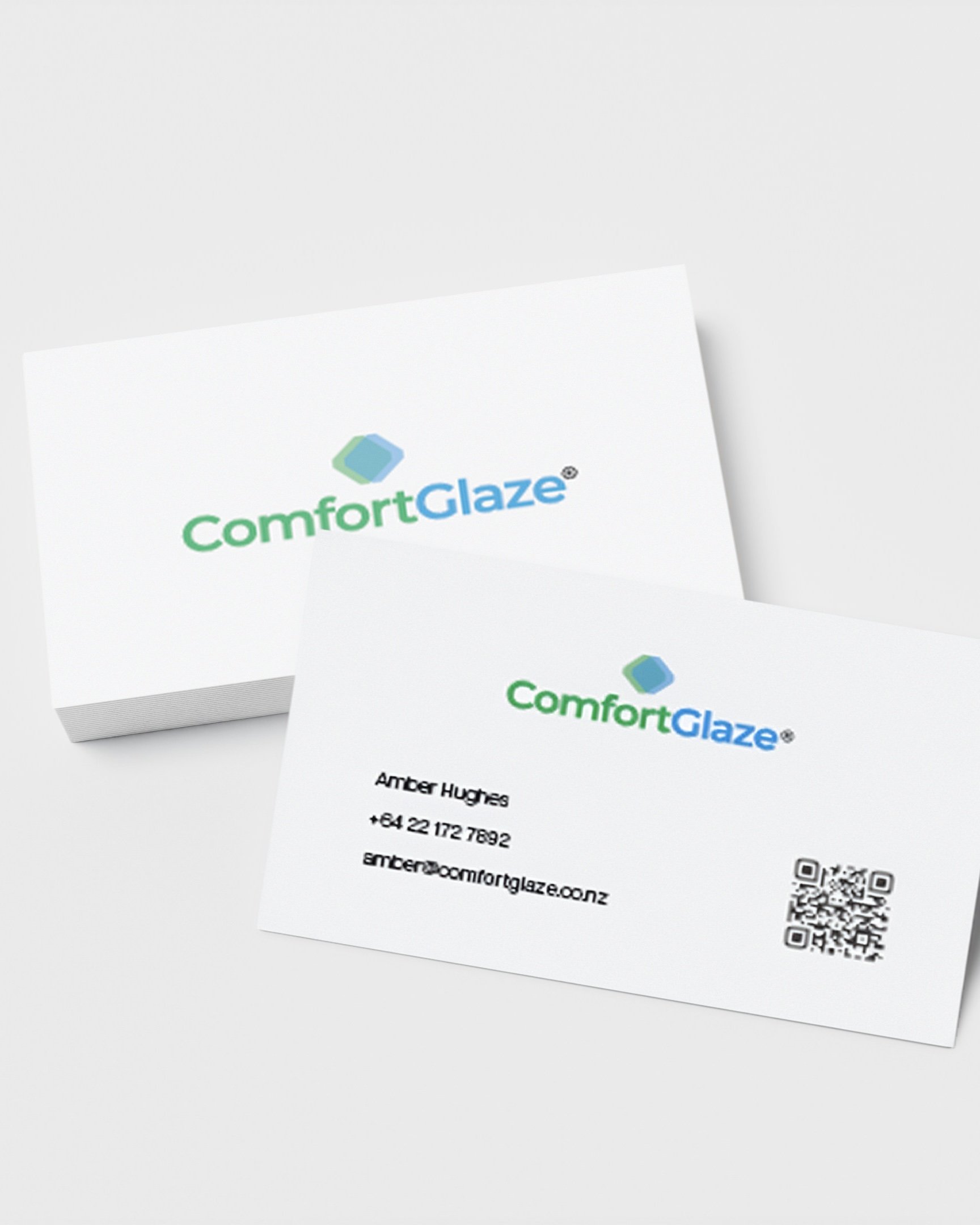 Business card and packaging for ComfortGlaze, a brand related to eye comfort or eye drops, with the logo, contact information for Amber Hughes, and a QR code.