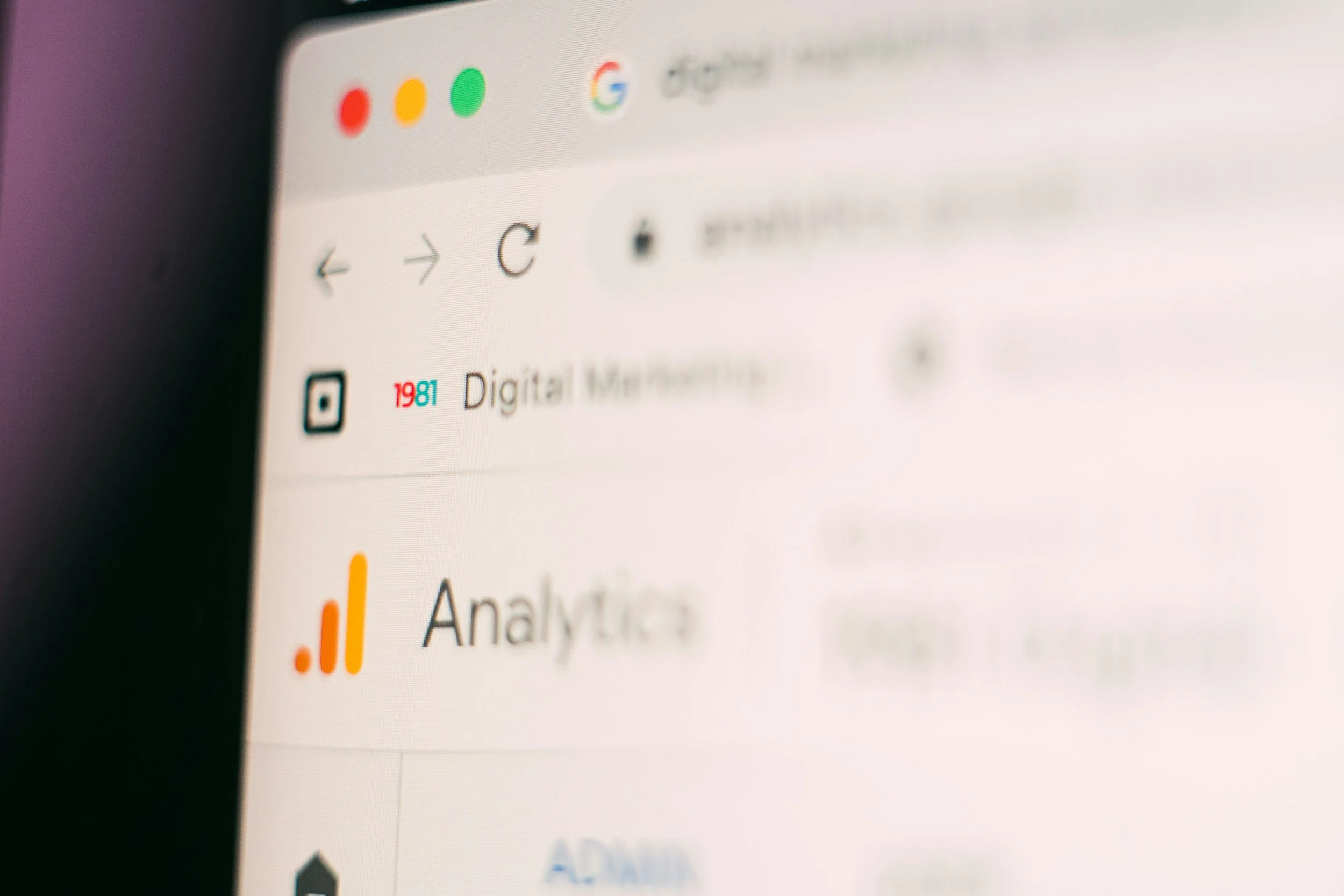 Close-up of a computer screen showing a web browser with a tab labeled 'Digital Marketing,' the Google Chrome logo, and an analytics application with an orange bar graph icon.
