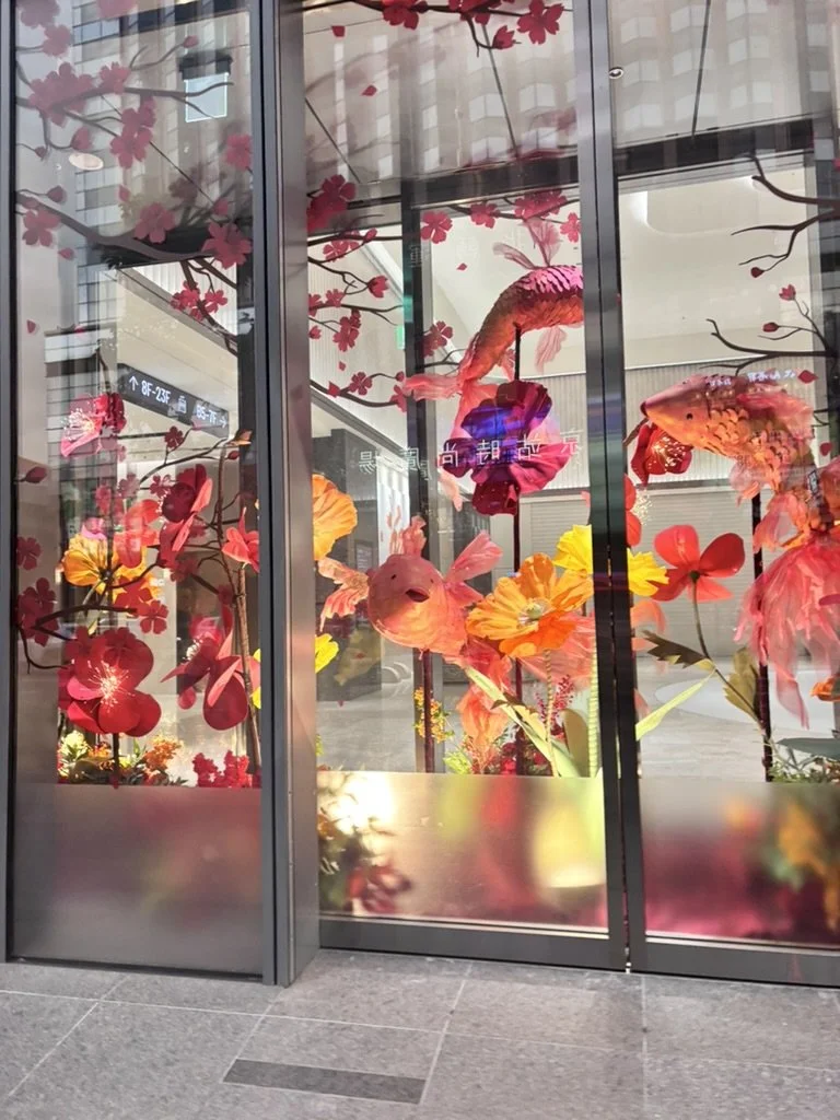 Decorative glass panels featuring colorful fish and flowers, with a mix of pink, orange, and yellow hues.