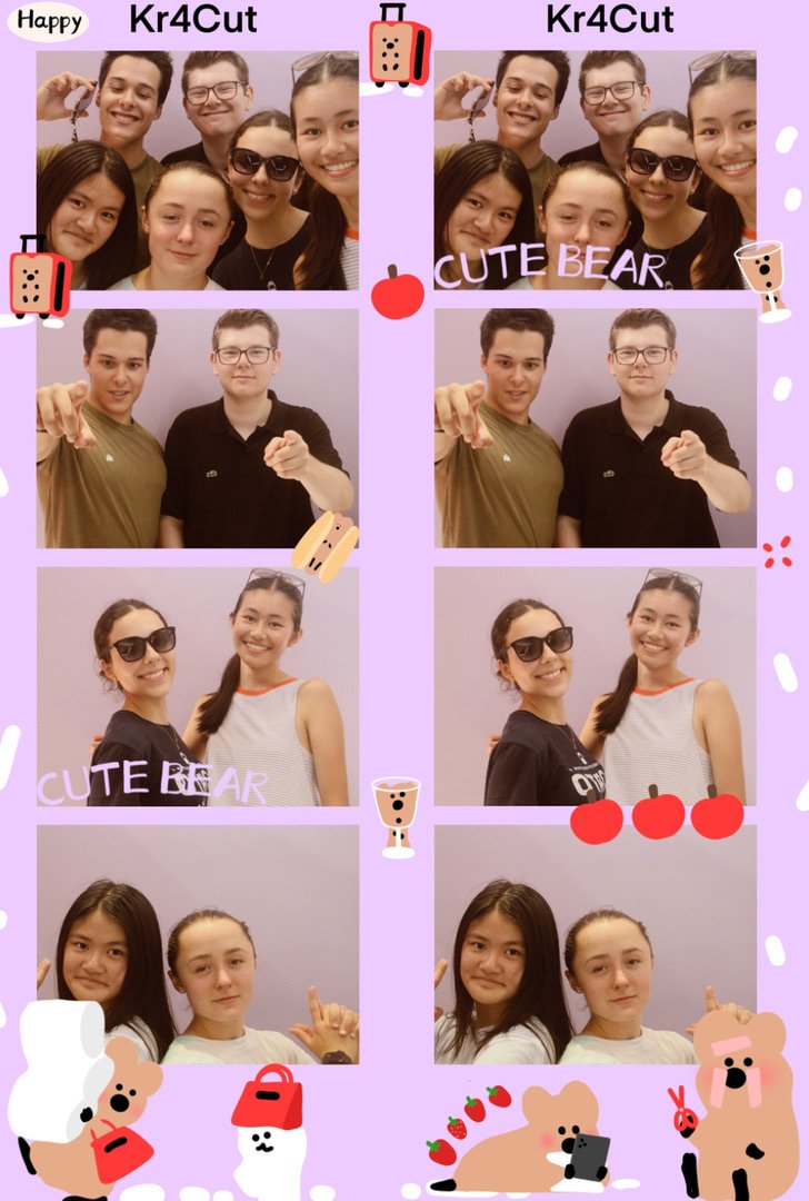 Group of six young people taking selfies in a photo booth, with four of them in the first set and four in the second set. The background is purple with cute sticker decorations such as bears, cherries, a suitcase, drinks, and other playful icons. Som