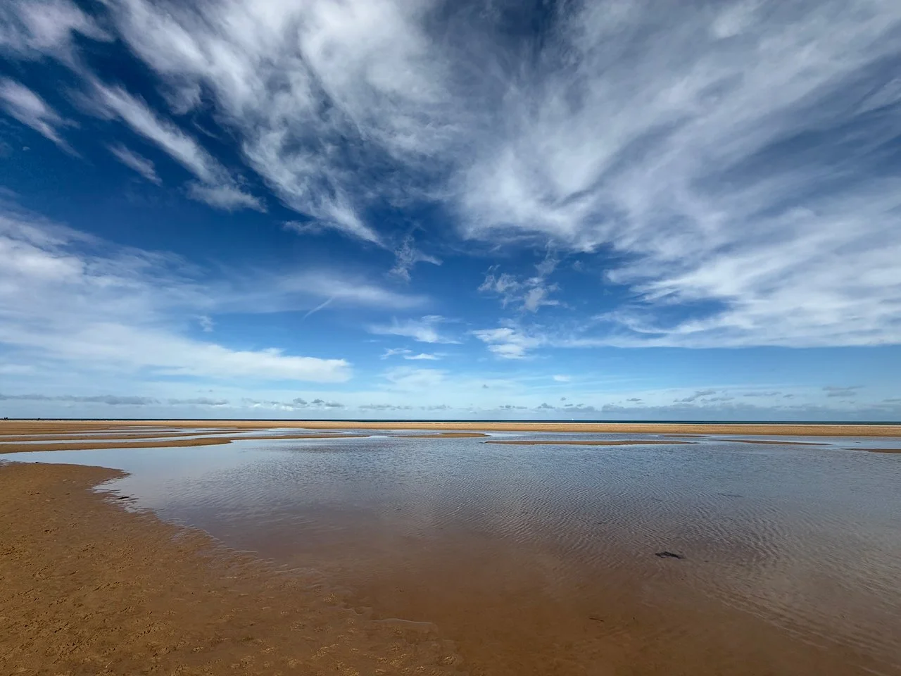 Mile after mile of sandy beaches make for incredible walks... or pick up your watercolours and try to capture skies like this