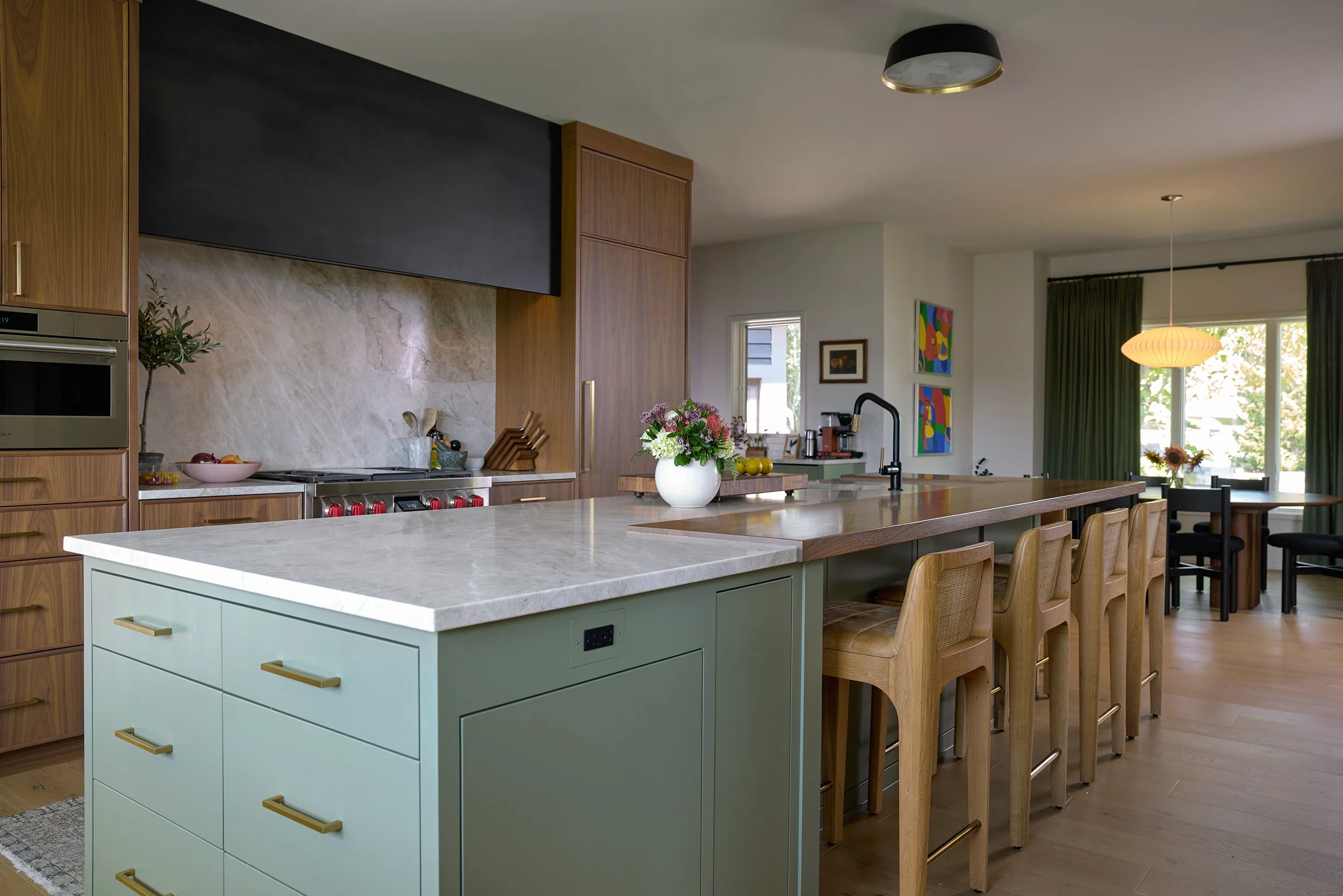 Bright open concept kitchen with flowers and art