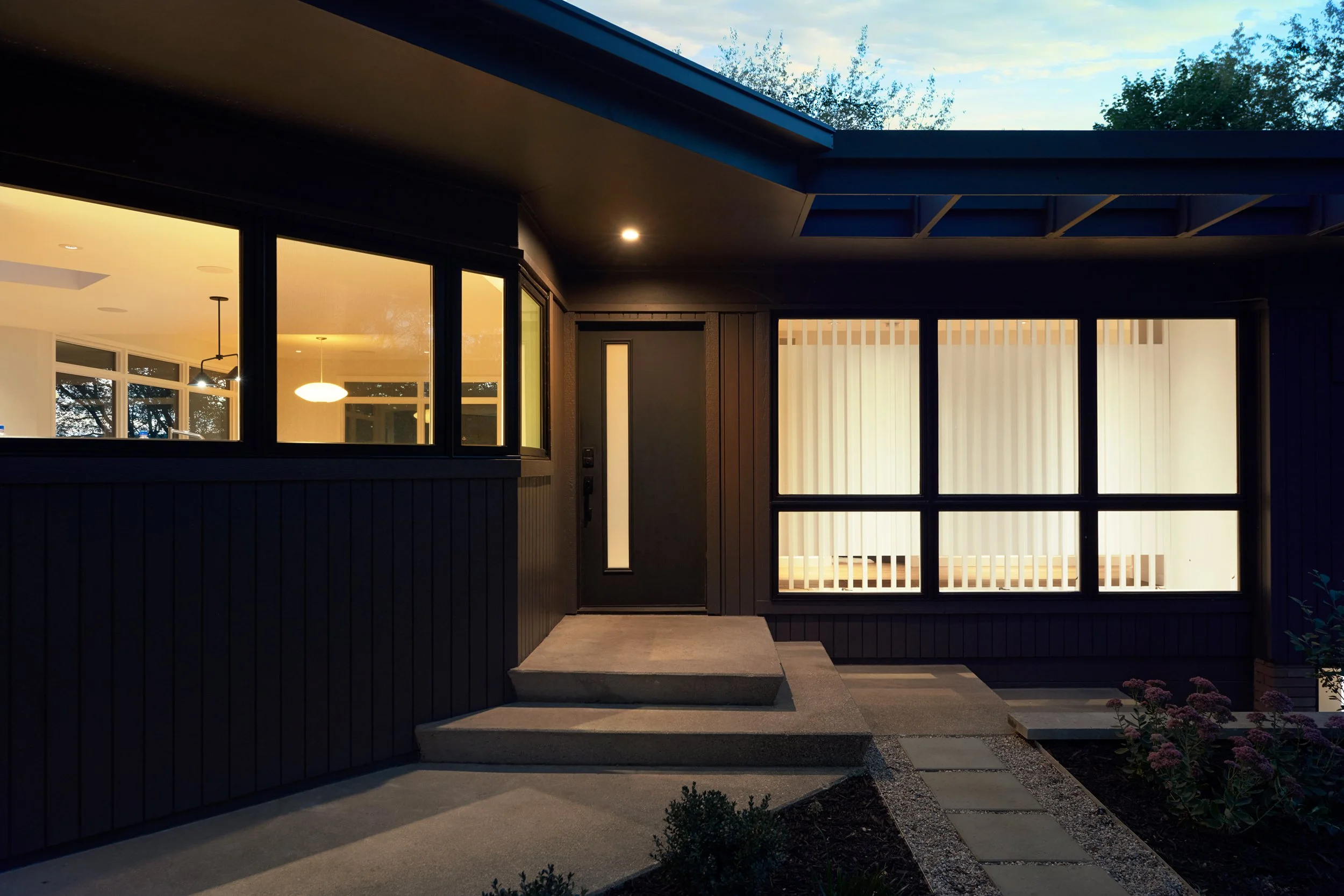 Illuminated exterior entryway to midcentury residence