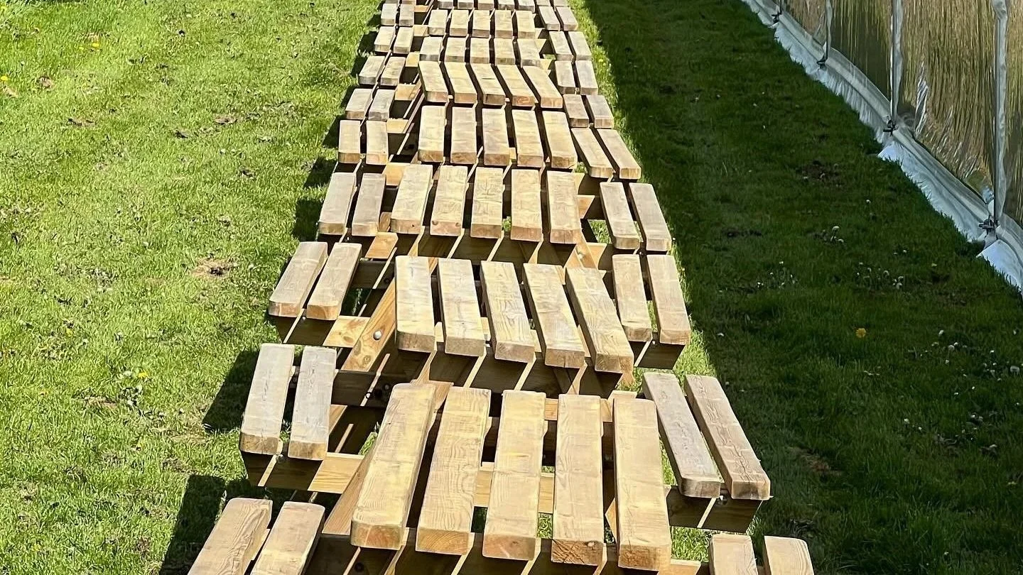 A row of high quality picnic benches available for hire in cornwall.