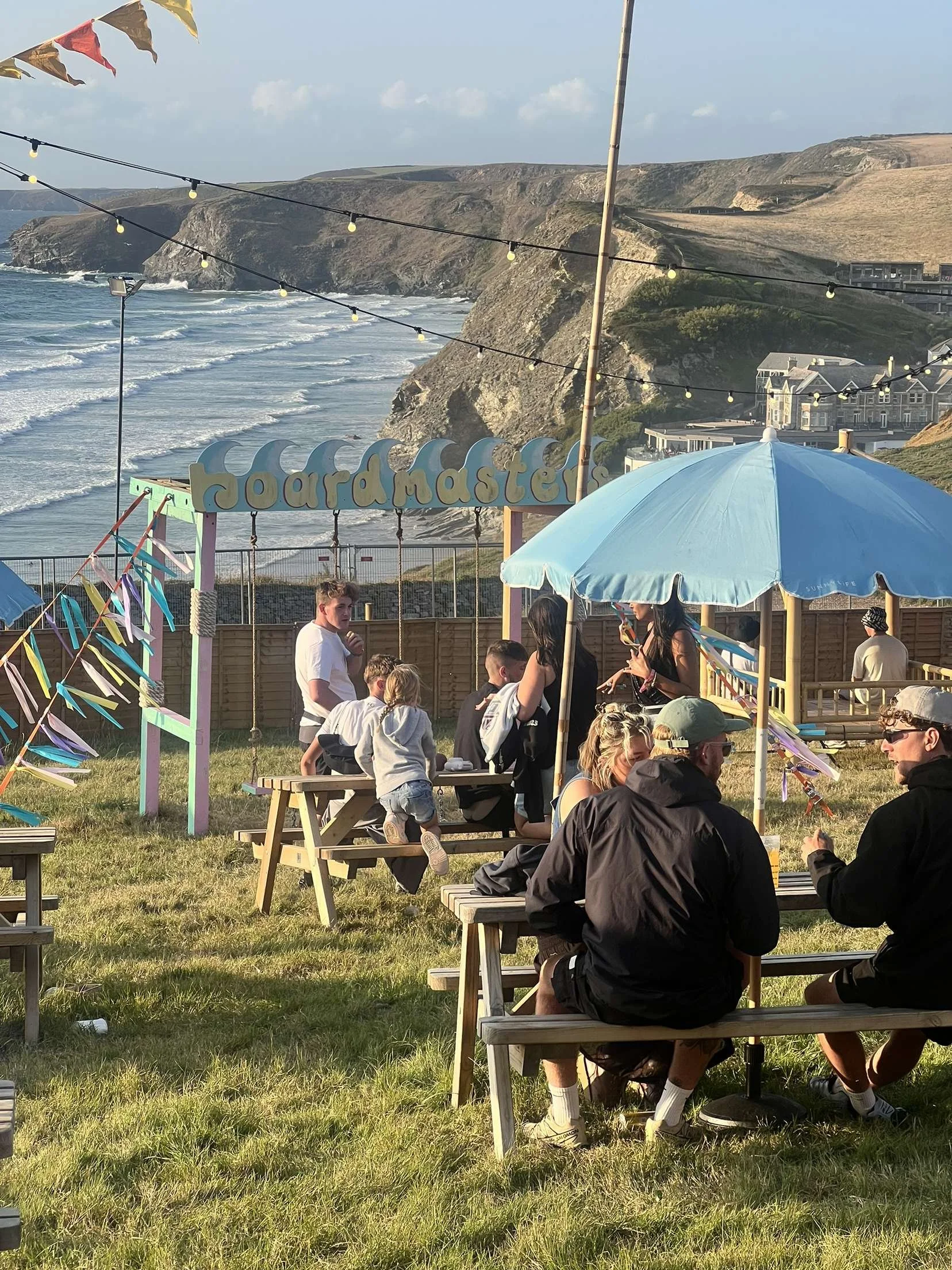 Festival picnic tables. People sat on picnic tables at a Cornish Festival.