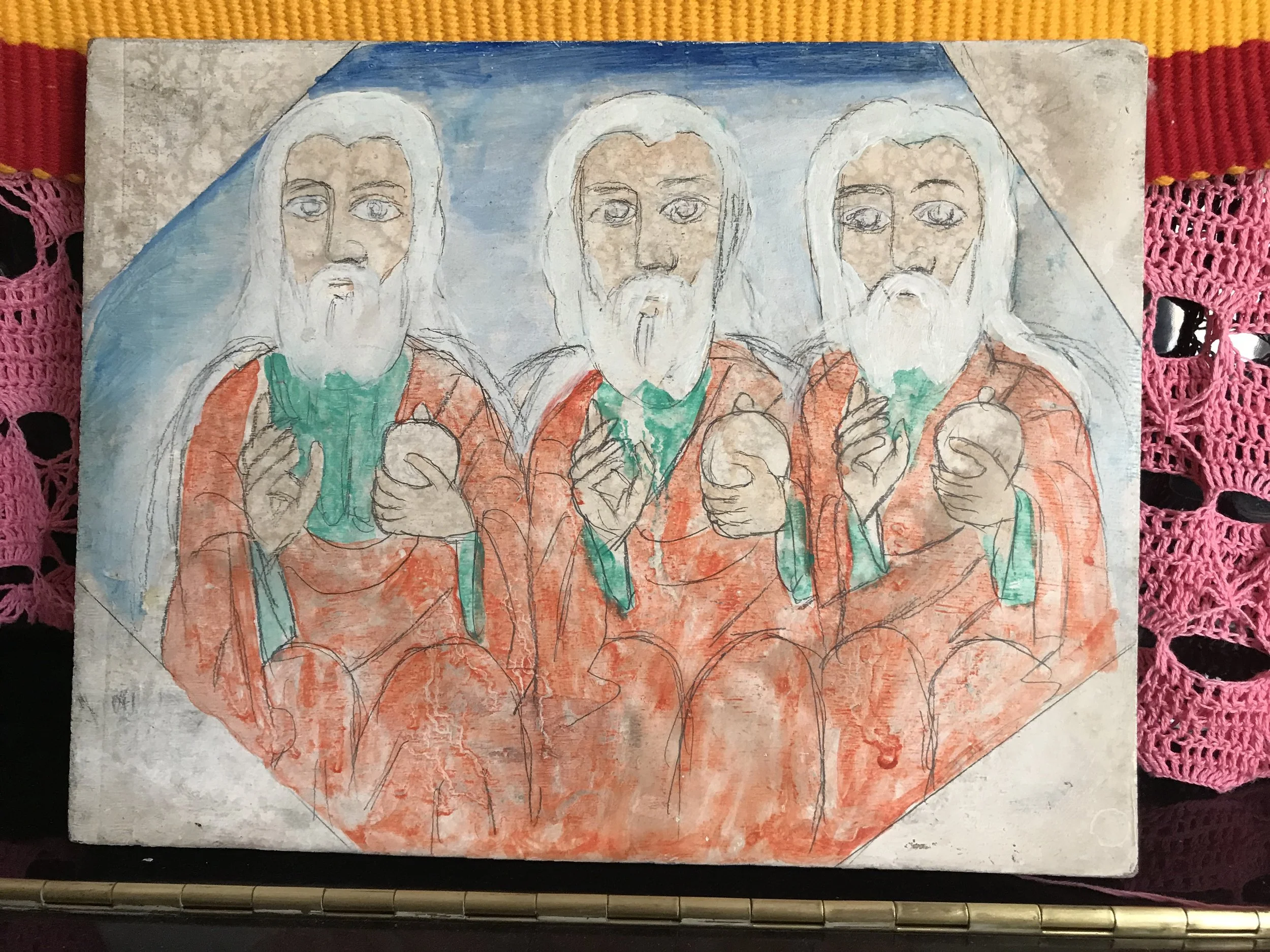 A colorful drawing of three figures with white hair and beards, wearing orange robes, with a blue background and a radiant halo around their heads.
