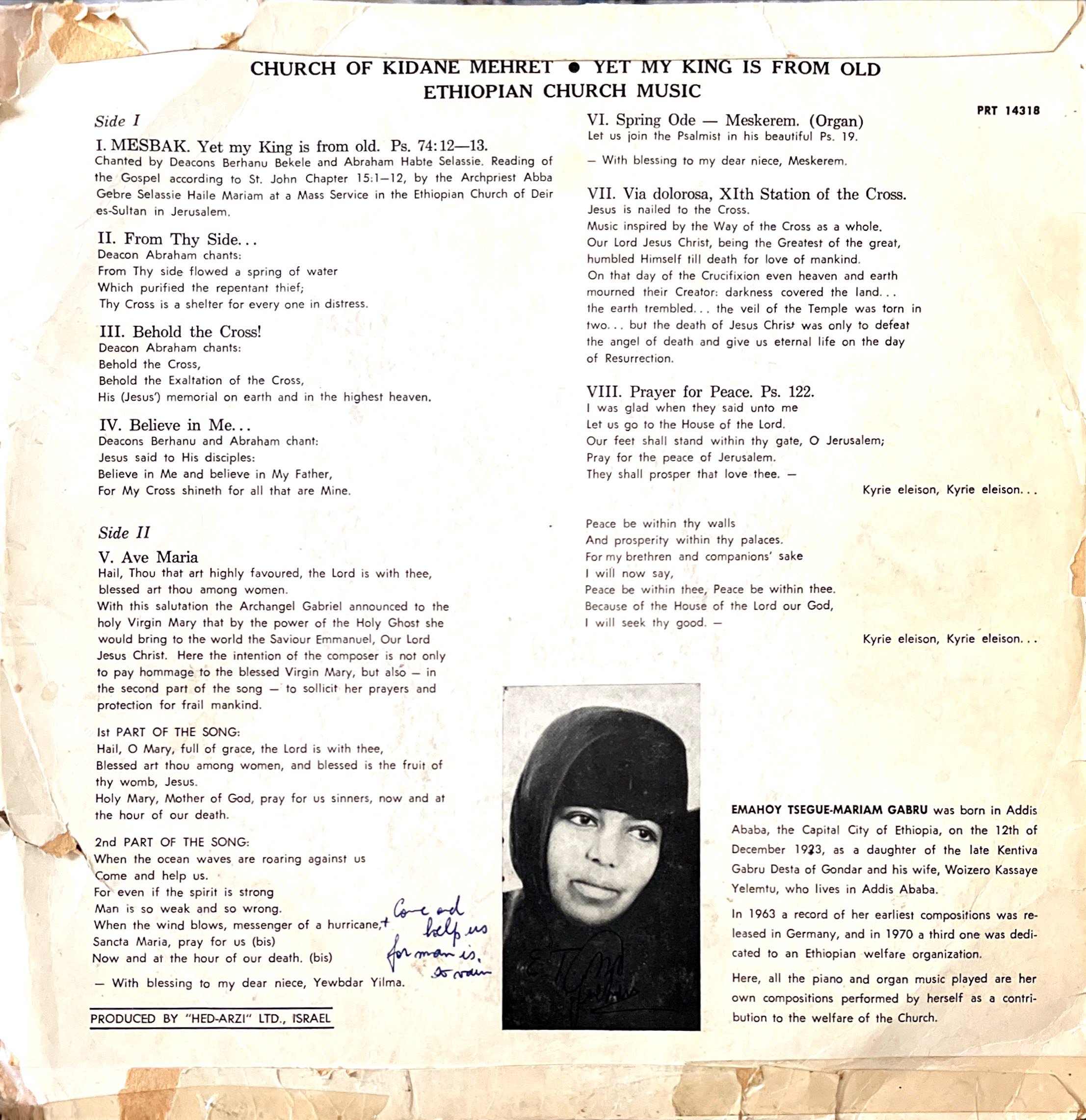 A worn sheet of paper with song lyrics, a black and white photograph of a woman, and handwritten notes. The document is titled "Church of Kidane Mehret" and includes lyrics to various Ethiopian church hymns, with some text in italics and different sections numbered. The paper shows tears, stains, and edges that are worn and damaged.