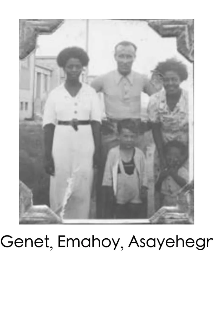 Black and white photo of four women and one child standing outdoors, with a wooden frame around the picture. The women are wearing dresses, and the child is dressed casually. The caption reads: "Genet, Emhoy, Asayegh."