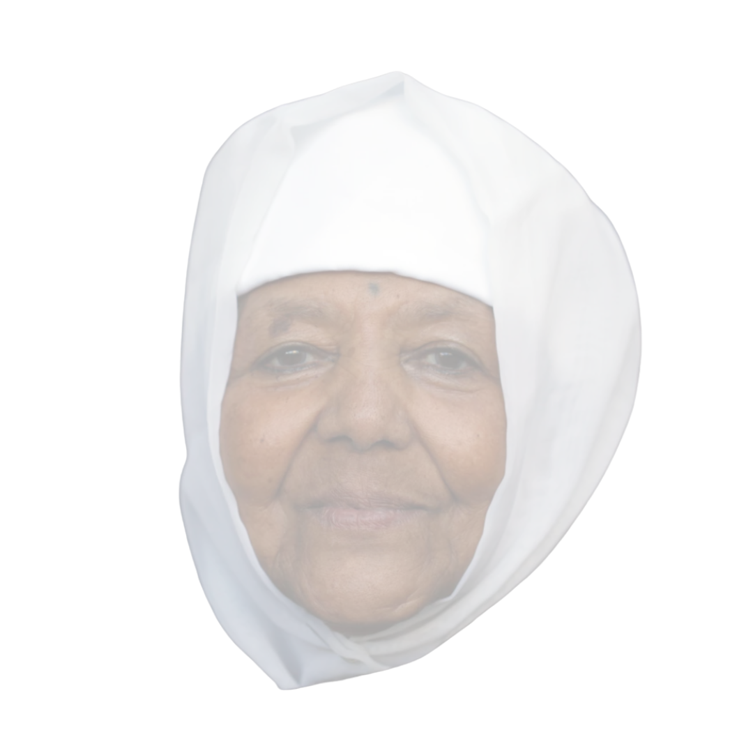 Close-up of an elderly woman with dark skin wearing a white head covering and smiling slightly.