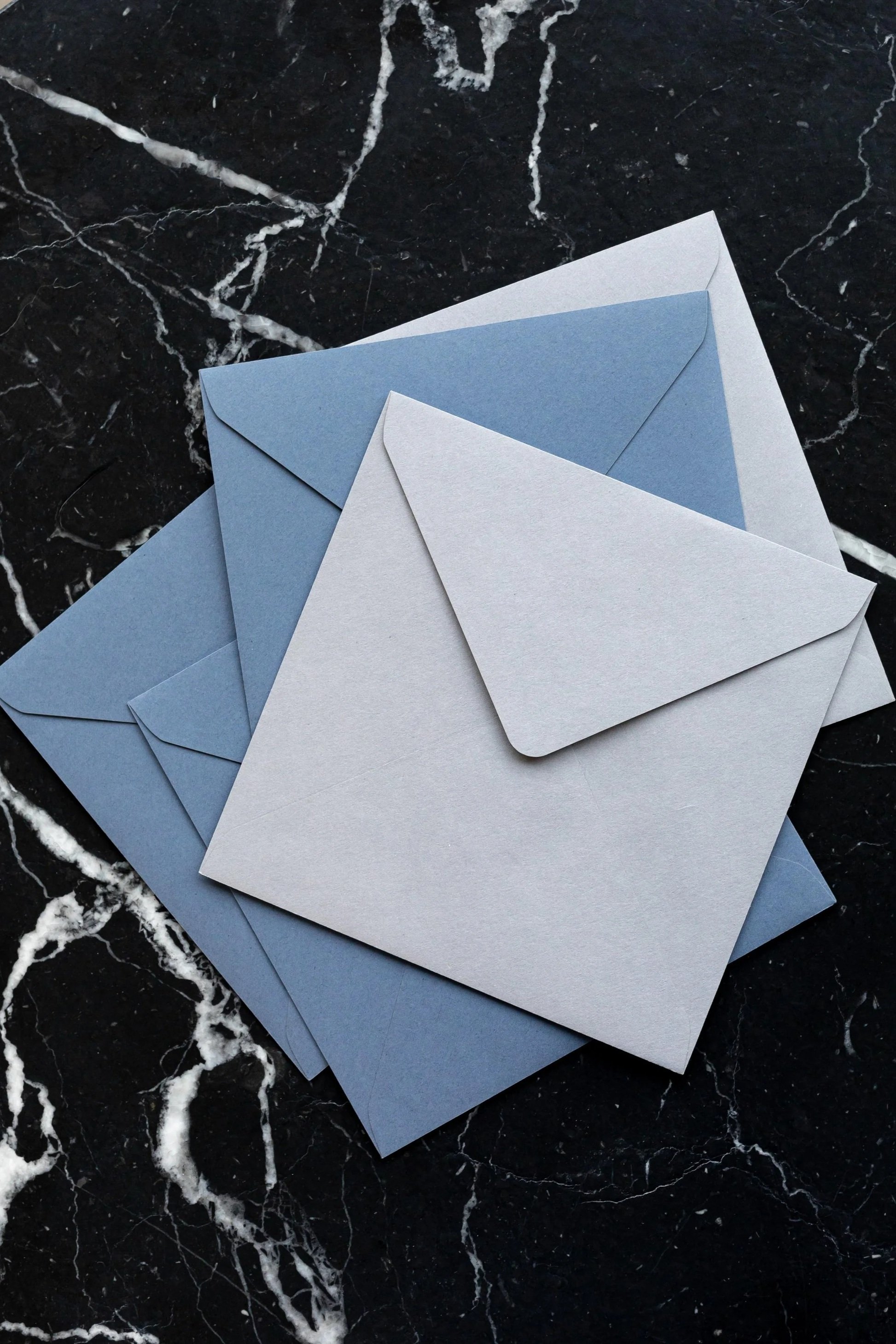 kaboompics_blue-white-envelopes-on-marble-16430.jpg