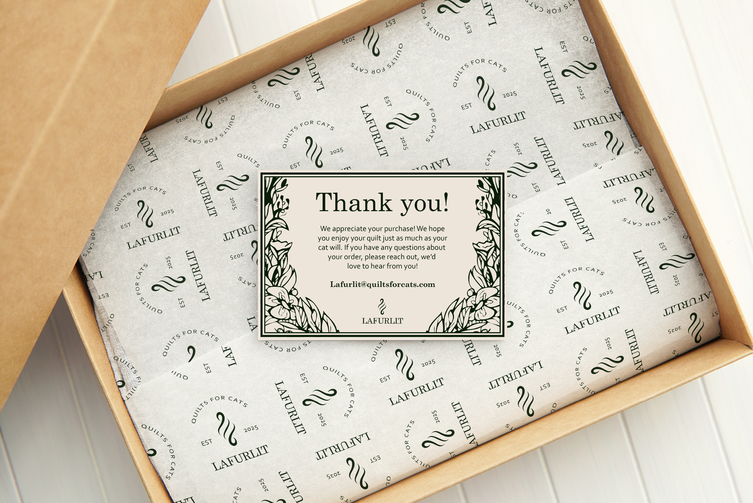 A thank you note inside a cardboard box with tissue paper lining, from LaFurlit, expressing appreciation for a purchase and providing contact information, placed on a white wooden surface.