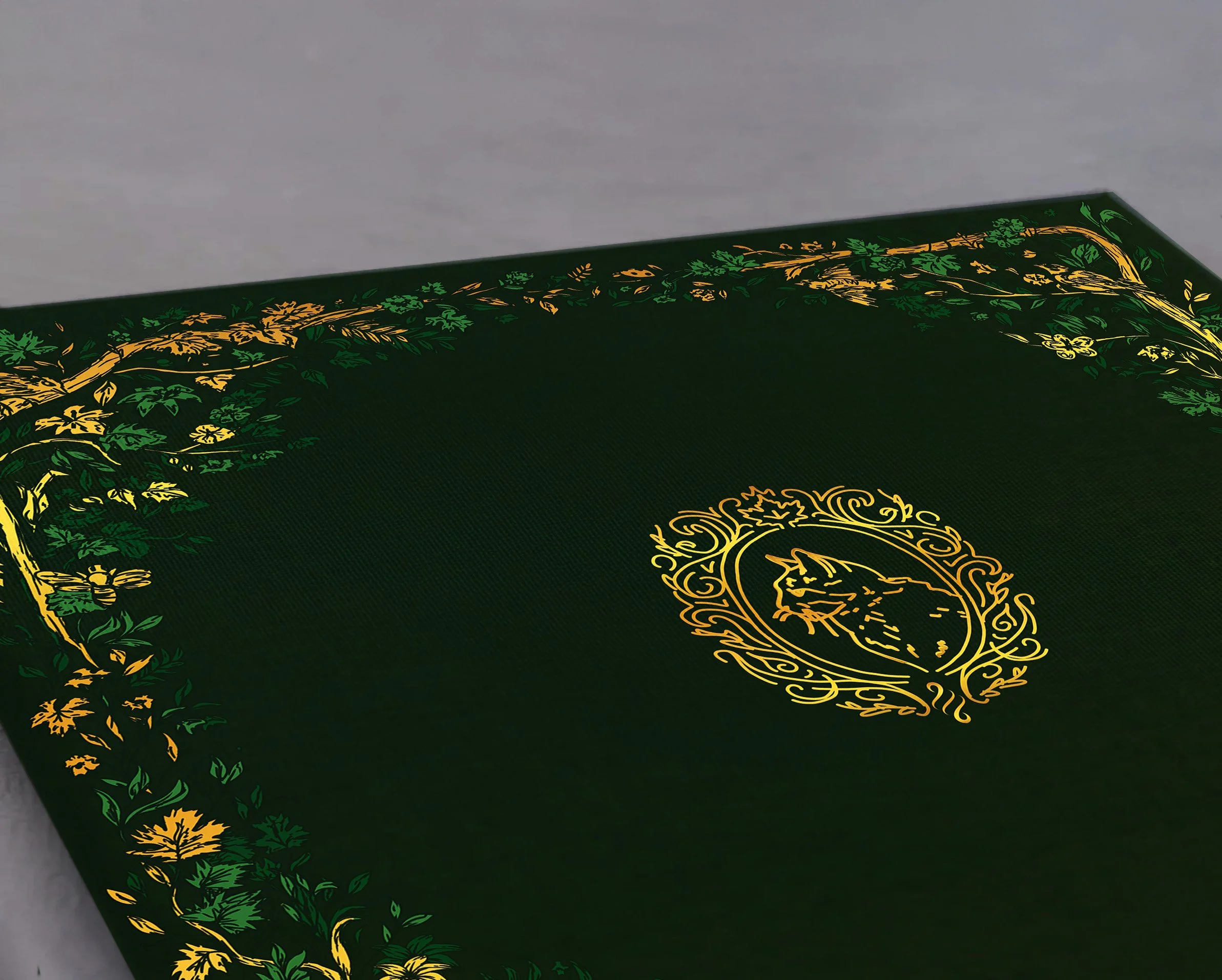 Close-up of a dark green box with gold and green decorative floral and vine designs along the edges and around a central emblem.