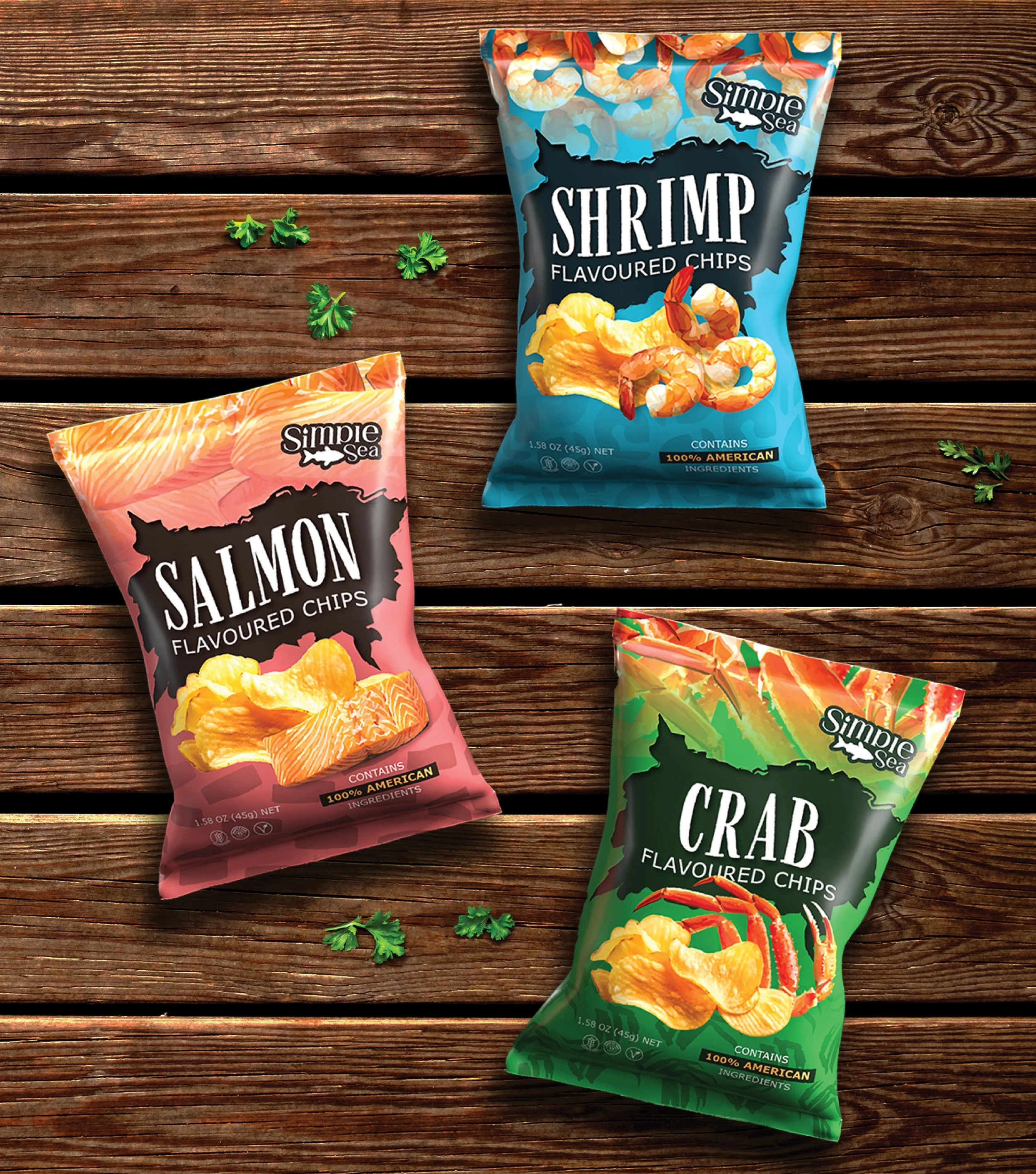 Three bags of flavored chips (shrimp, salmon, crab) on a wooden surface, with small green parsley leaves scattered around.