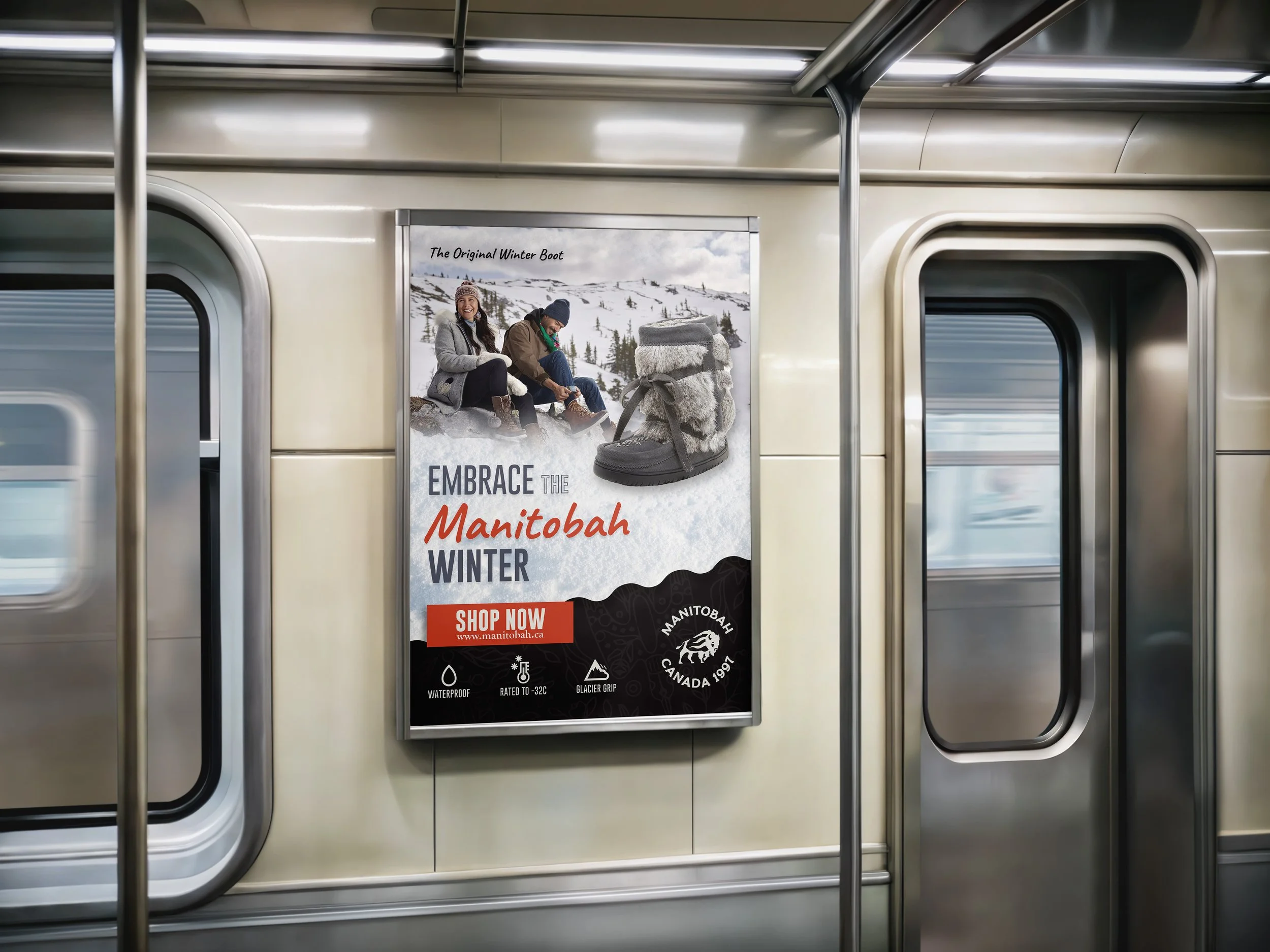 Advertisement for Manitoba winter boots on a subway train wall featuring two people in winter clothing and a close-up of the boots with snow and mountain background.