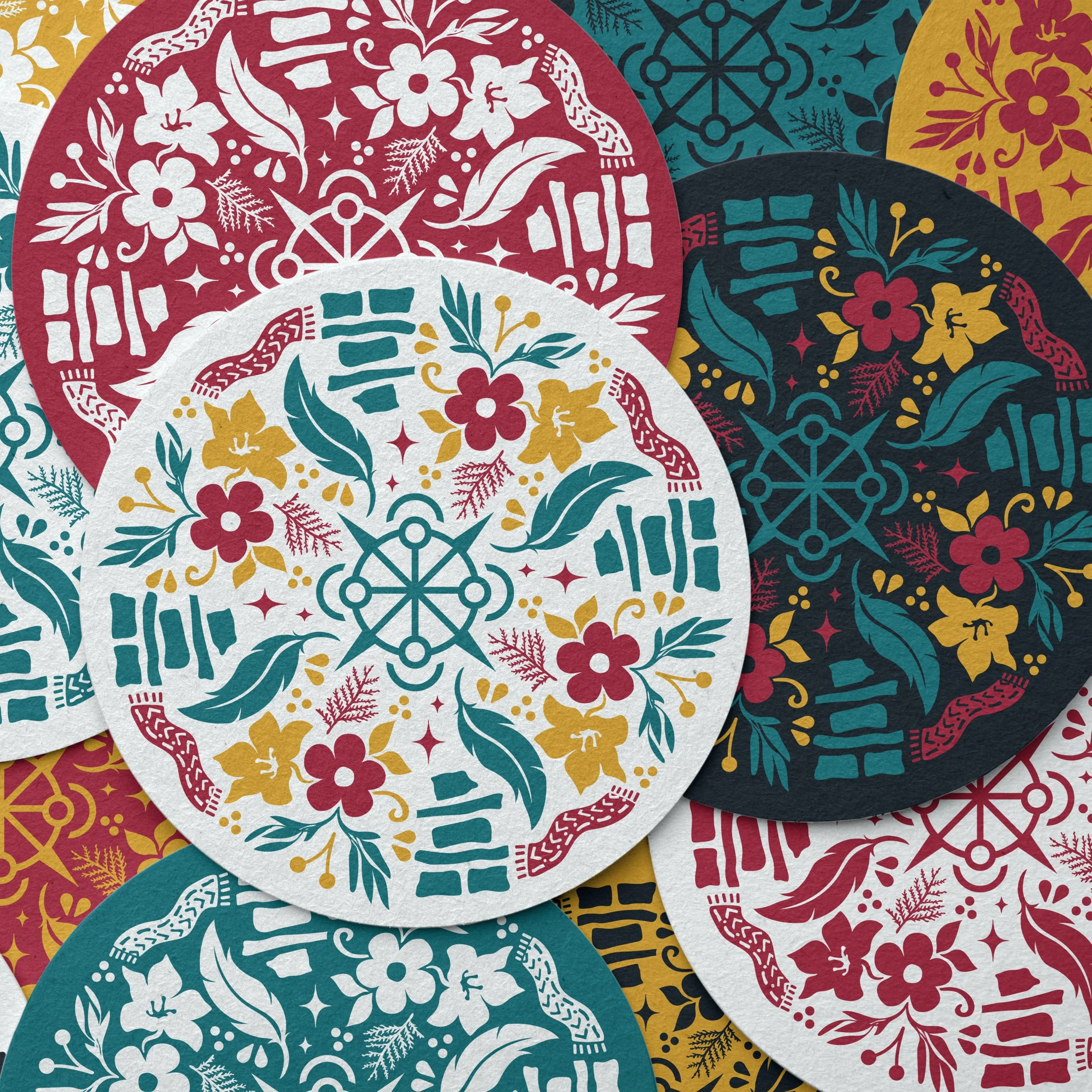 Colorful paper cutouts featuring Christmas-themed designs with the word 'Ho Ho Ho' and floral patterns in red, white, teal, and black.