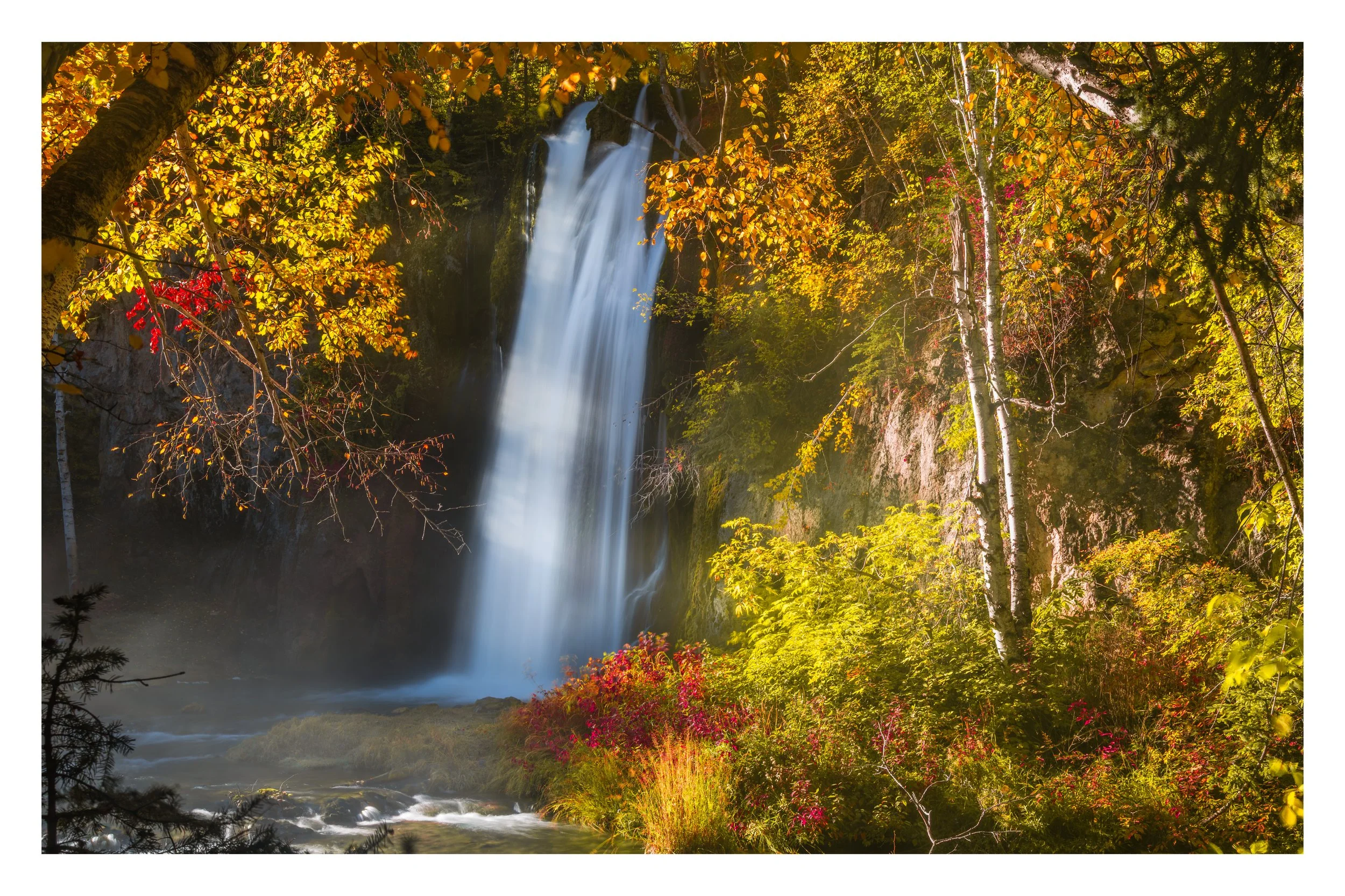 Waterfall Framed by Autumn Leaves