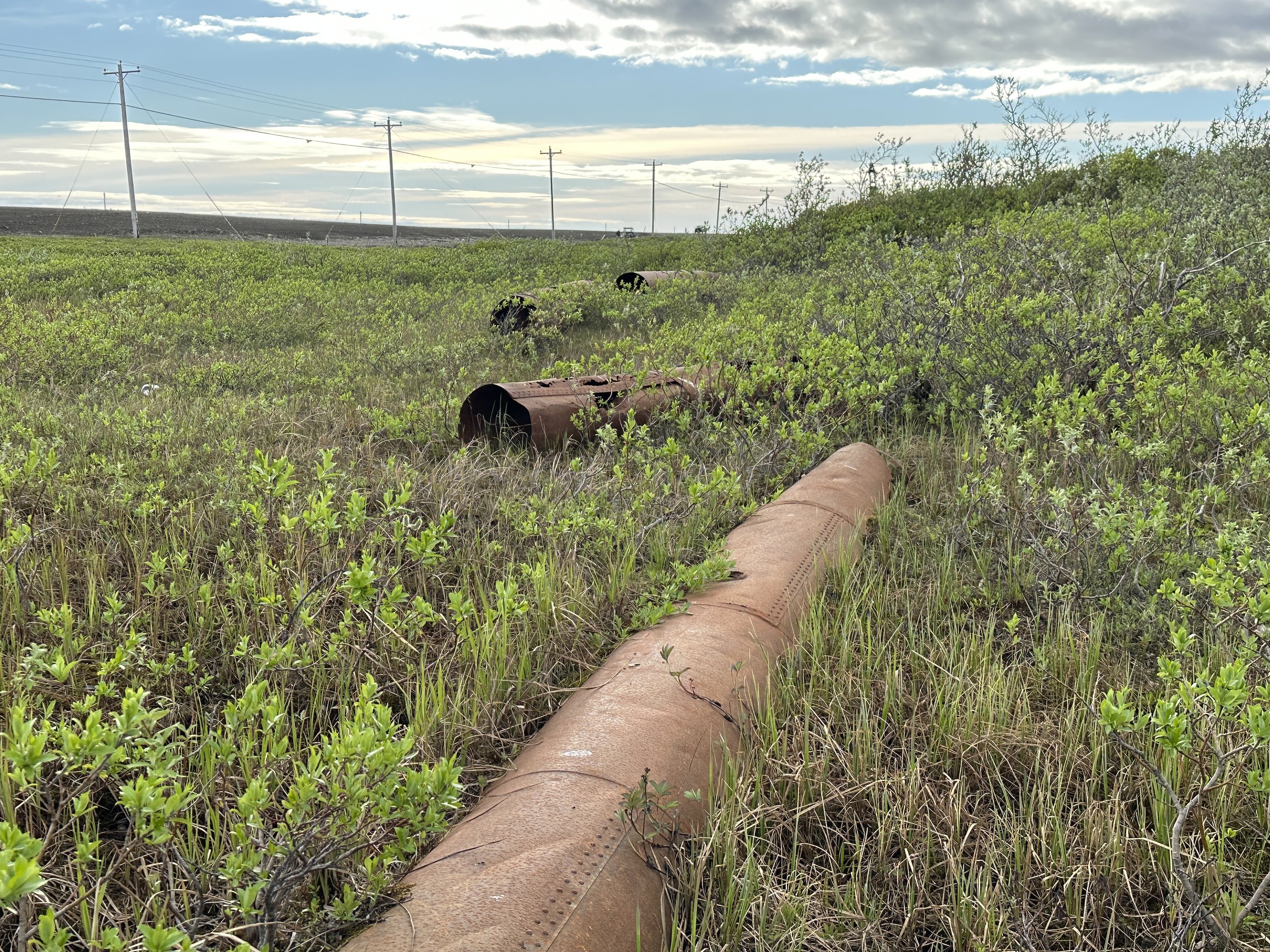 Contaminated site with abandoned fuel piping and debris requiring environmental site characterization and cleanup in Alaska
