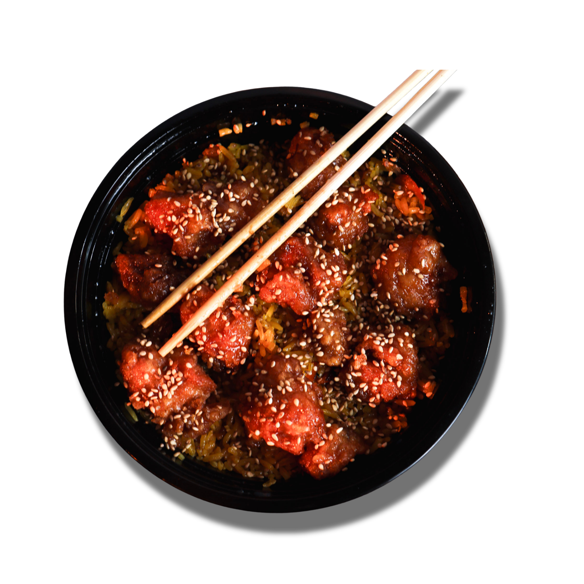 Top-down view of a black bowl containing Asian-style chicken with sesame seeds, placed on a black background, with chopsticks resting on top.