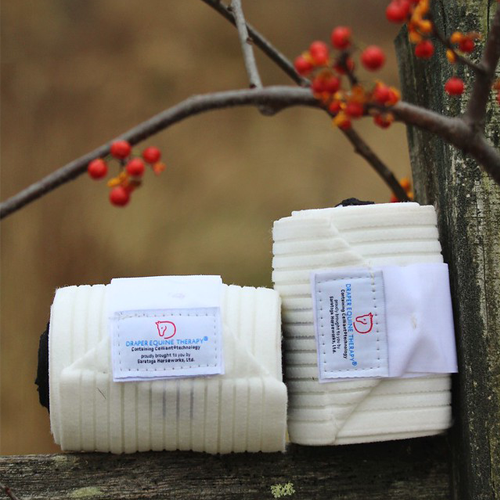 Draper Therapies Perfect Polo Wraps in classic white, resting on a rustic fence with autumn berries in the background